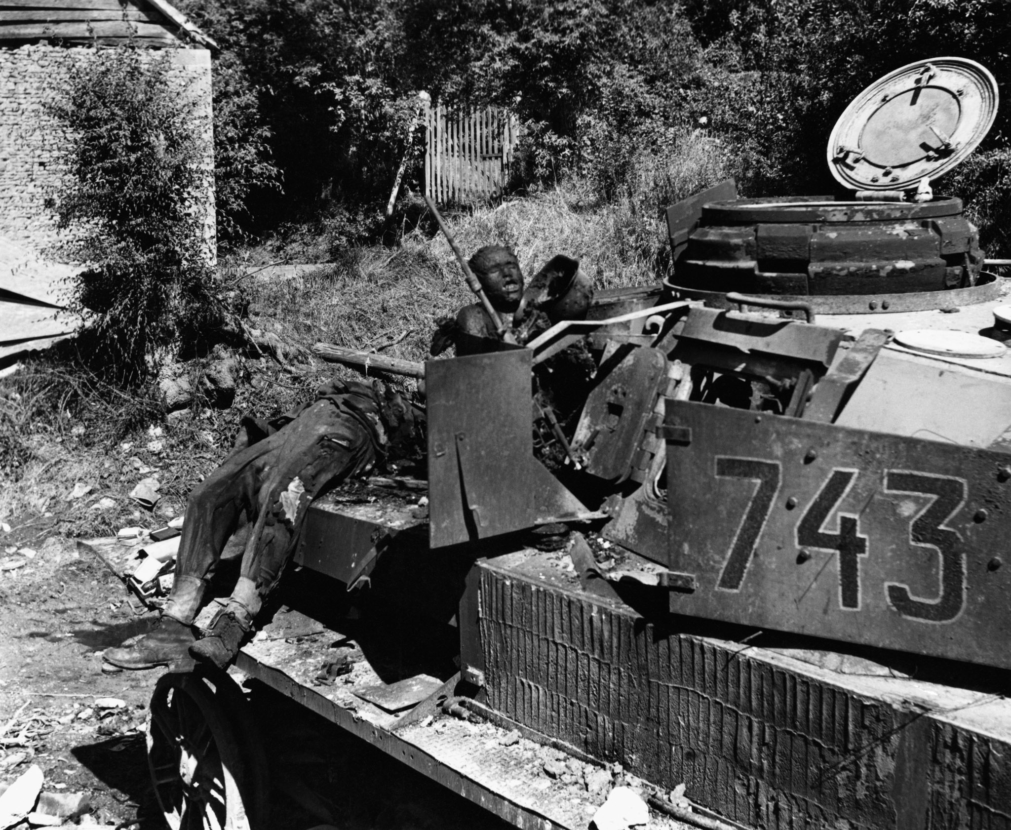 Dead soldiers sprawled on a tank in northwest Europe, circa 1944.