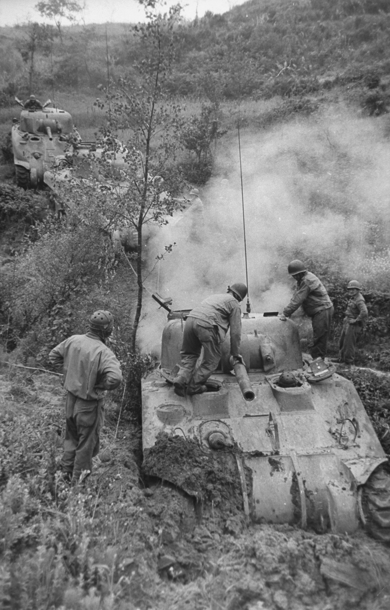 Tank crews fight to free bogged-down M4 Shermans in the countryside near Minturno, Italy, 1944.