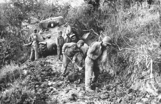 American soldiers widen dirt road near Minturno, Italy, 1944.