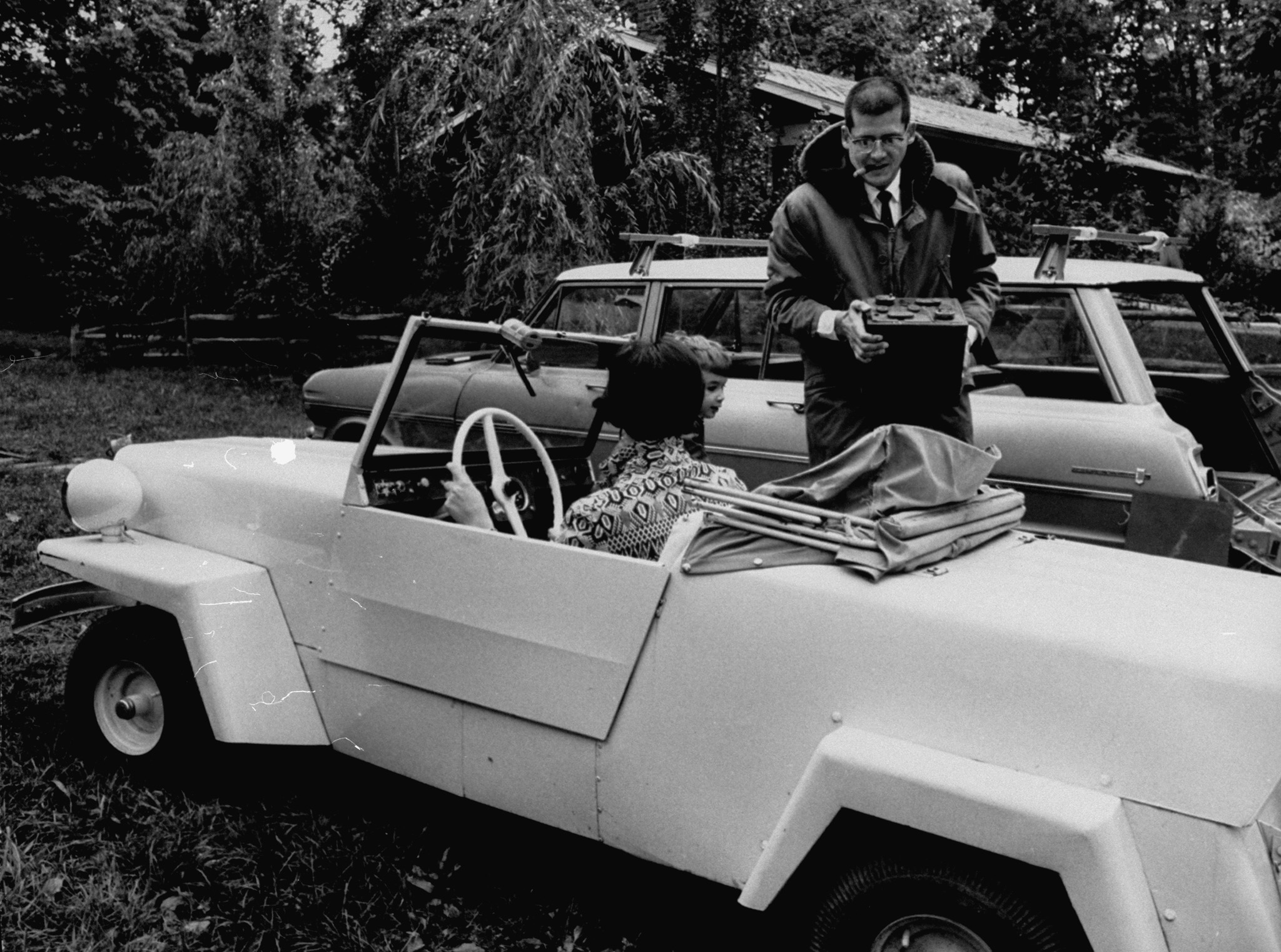 Washington, D.C., writer John Hoke, with the 35-mph electric car he built himself for less than $1,000, 1966.