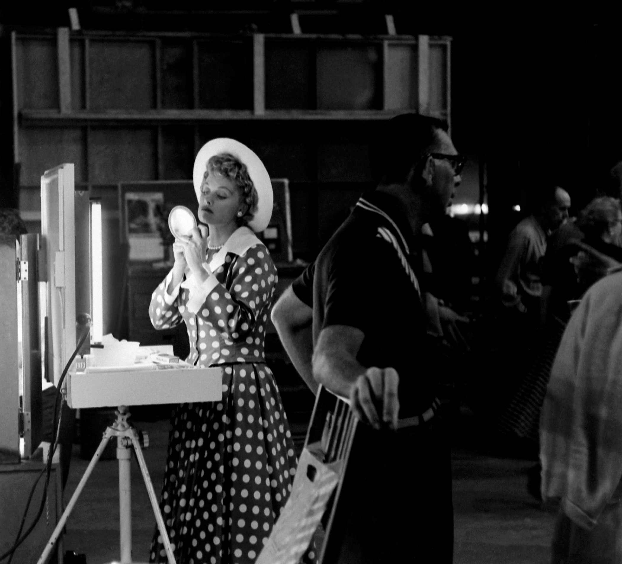 Lucille Ball is a calm eye at the center of a storm of activity at her new Desllu Studios, 1958.