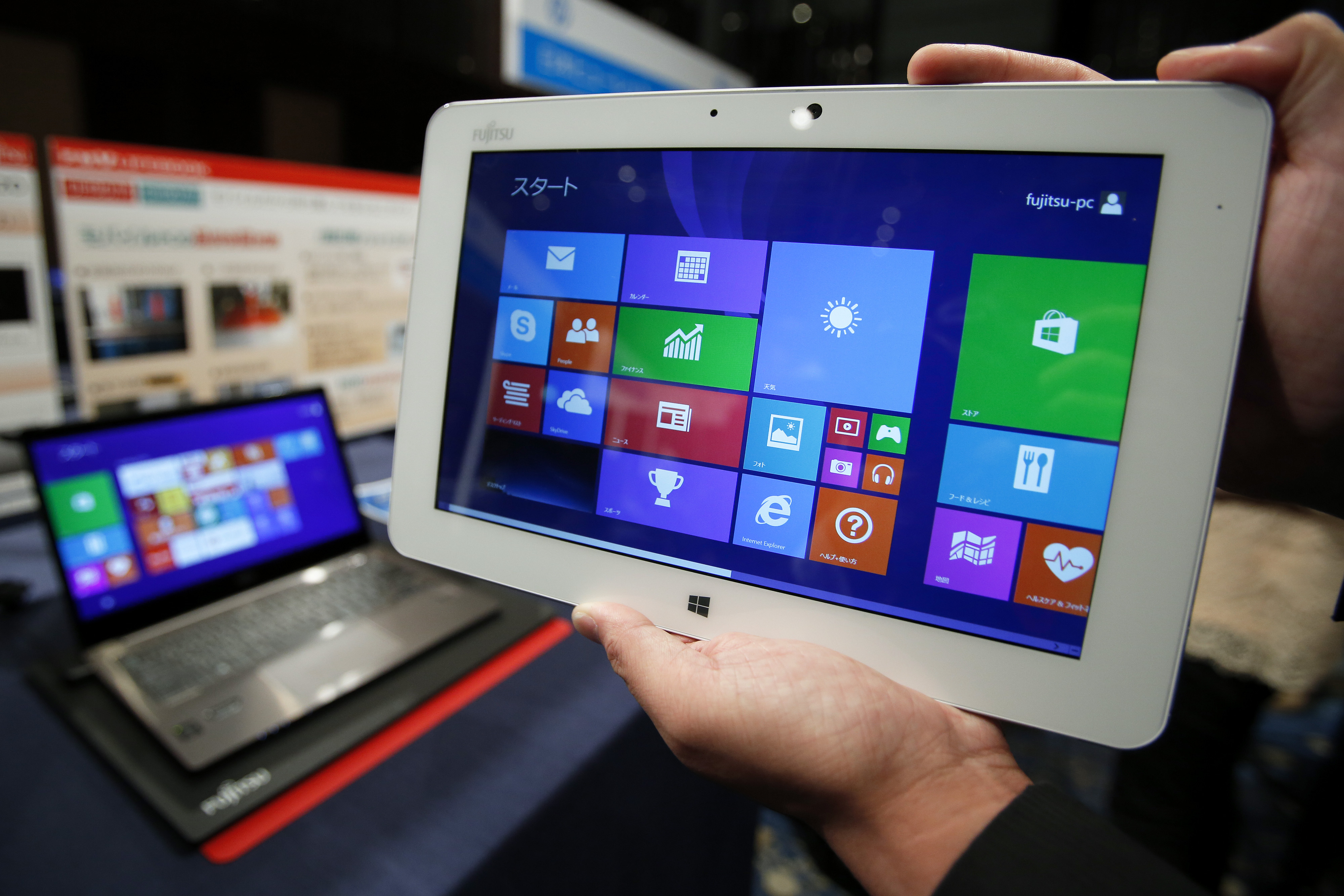 An attendant displays a Fujitsu Ltd. Arrows Tab tablet, running Microsoft Corp.'s Windows 8.1 operating system, during a launch event for the operating system in Tokyo, Japan, on Friday, Oct. 18, 2013. (Bloomberg—Bloomberg via Getty Images)