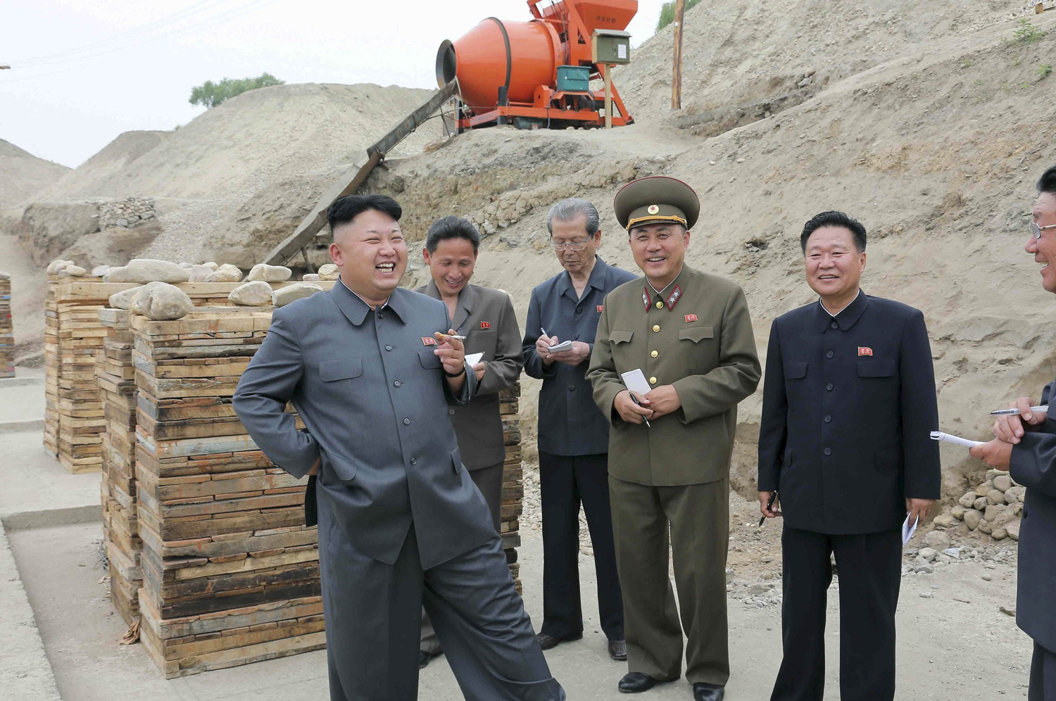 North Korean leader Kim Jong Un smokes a cigarette as he gives guidance on the development of Ssuk Islet