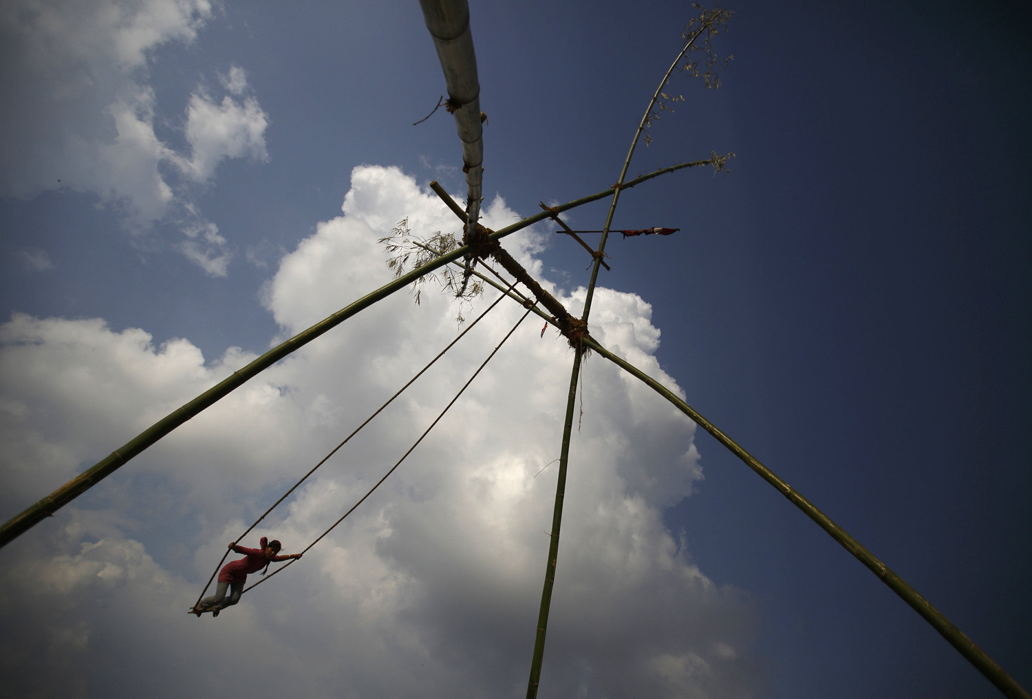 A girl plays on a traditional swing during the Dashain, Hinduism's biggest religious festival, in Kathmandu
