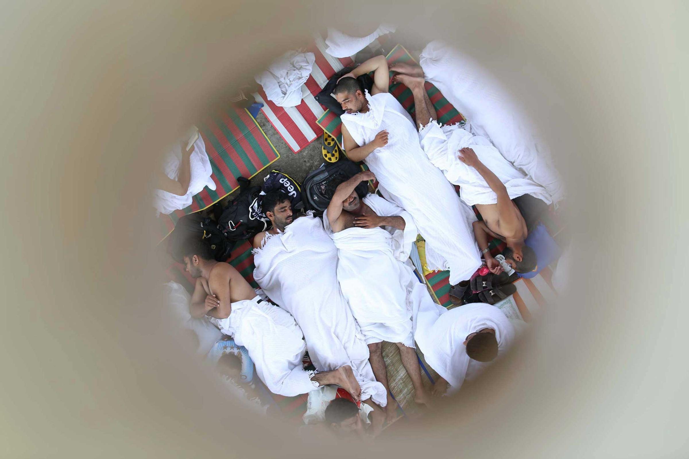 Muslim pilgrims are pictured through a roof opening as they sleep during the annual haj pilgrimage in Mena, near the holy city of Mecca