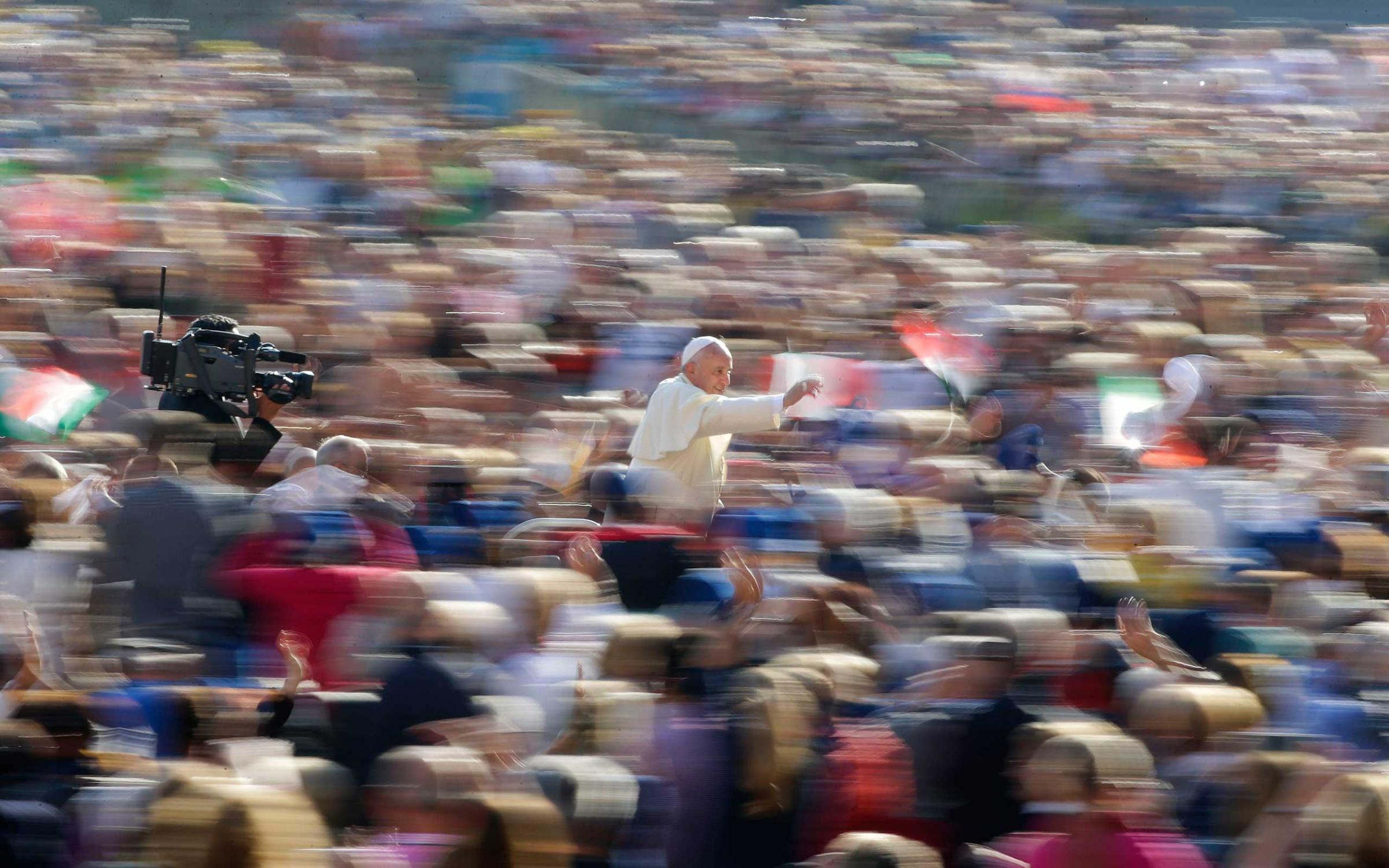 Pope Francis waves as he leads his weekly audience in Saint Peter's Square at the Vatican