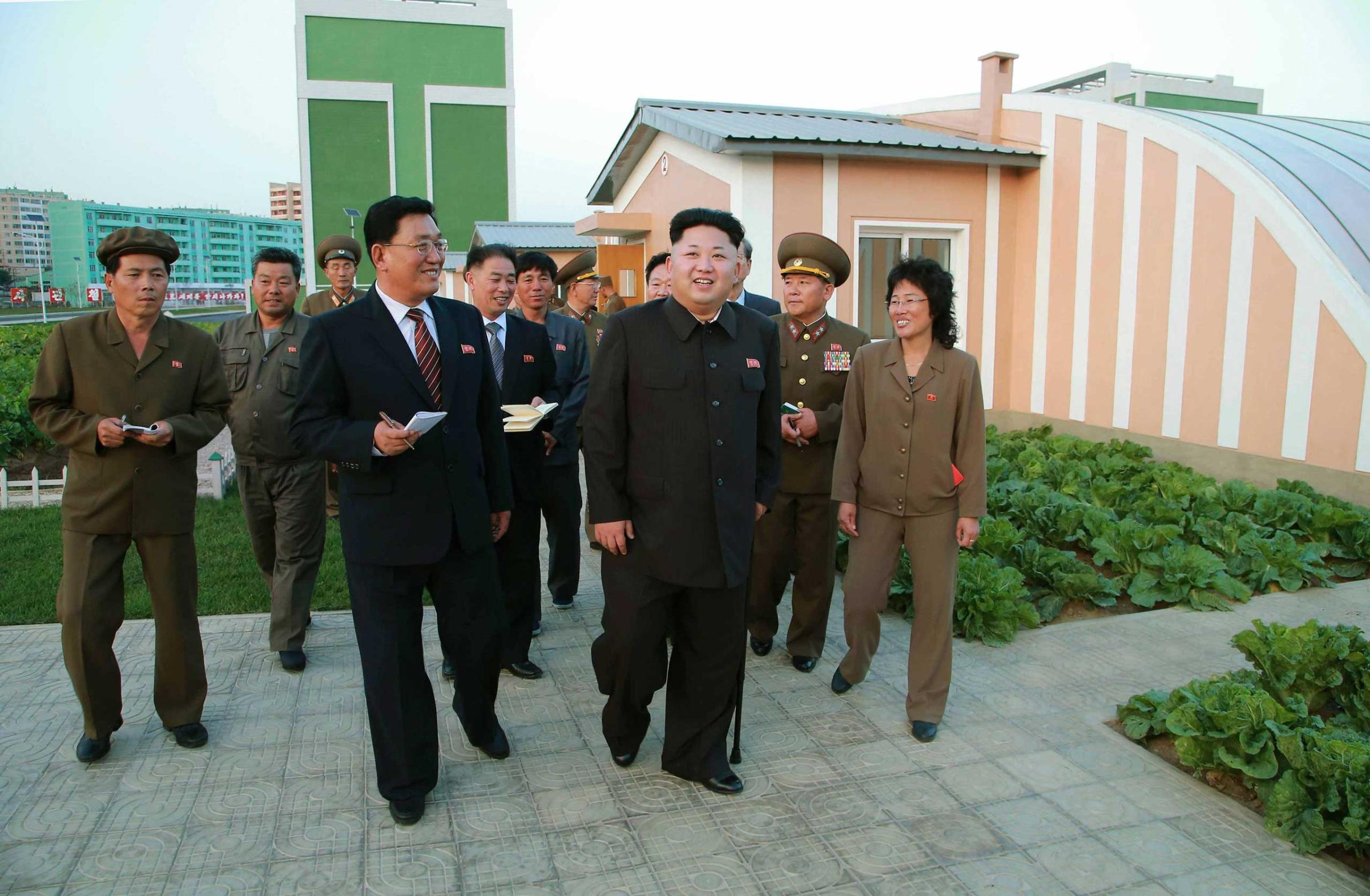 North Korean leader Kim Jong Un gives field guidance at the newly built Wisong Scientists Residential District  in this undated photo released by KCNA