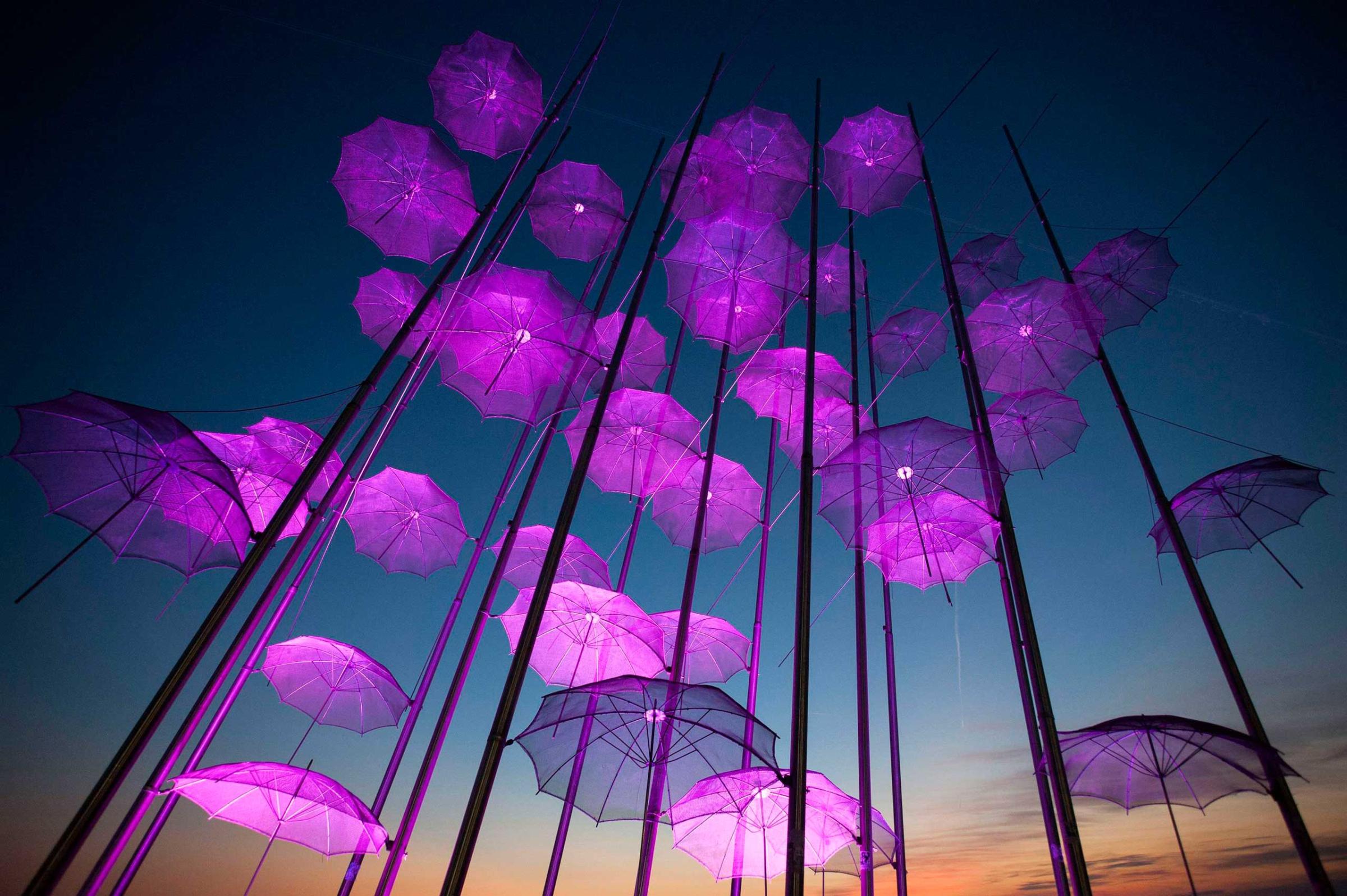 "Umbrellas", the sculpture by Giorgos Zogolopoulos is illuminated in pink light to mark Breast Cancer Awareness Month in Thessaloniki in northern Greece