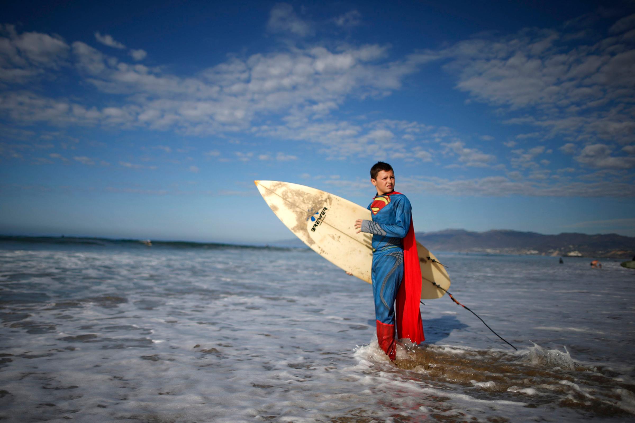 Catello Dannunzio, 12, prepares to compete as Superman during the 7th annual ZJ Boarding House Haunted Heats Halloween surf contest in Santa Monica