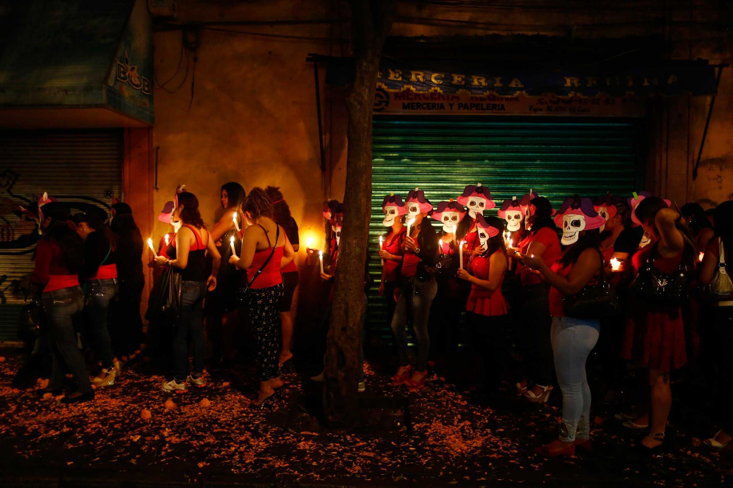 Sex workers wear skeleton masks during a procession to remember their deceased colleagues, in Mexico city