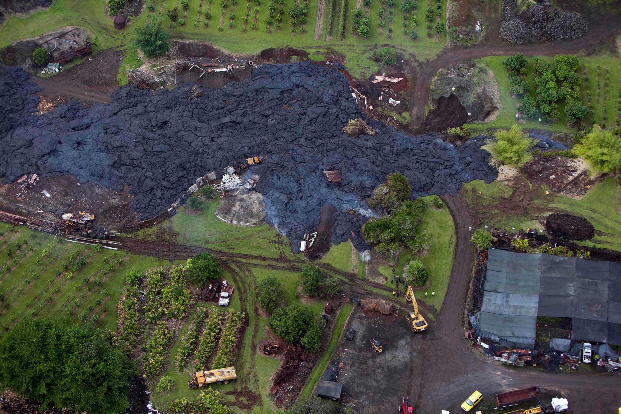Construction crews try divert lava from Mt. Kilauea from a home in the village of Pahoa, Hawaii