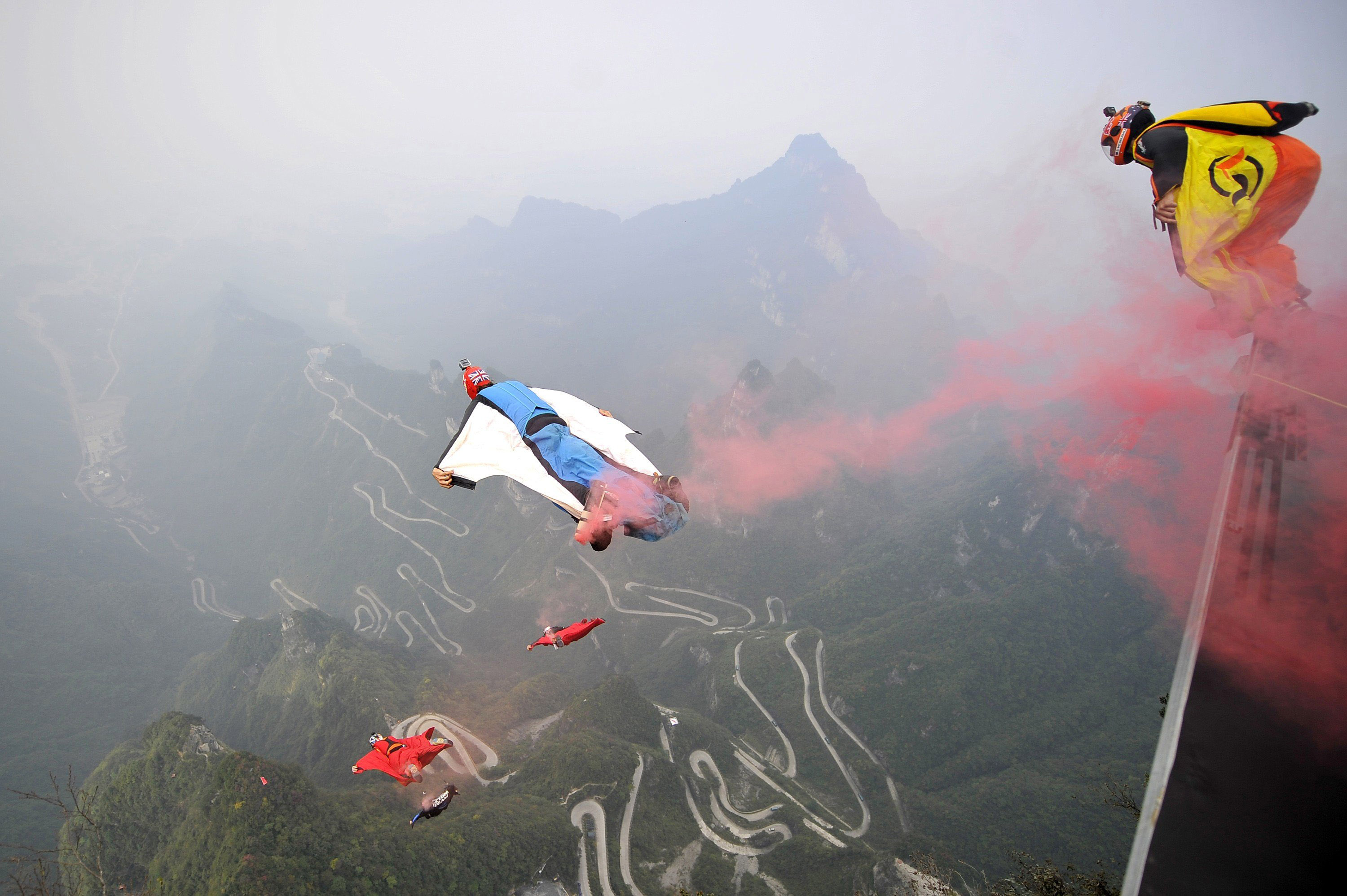 Wingsuit flyer contestants jump off a mountain at Tianmen Mountain National Park in Zhangjiajie, Hunan province, China on Oct. 19, 2014.