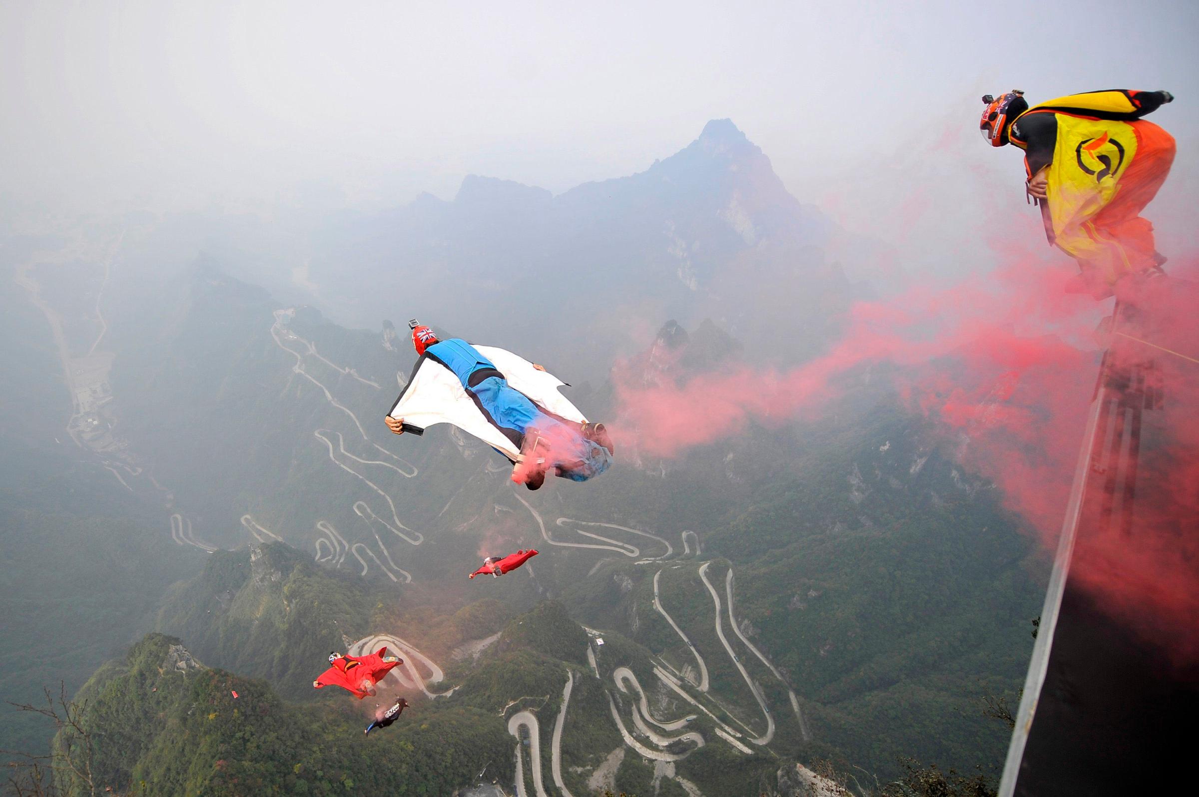 Wingsuit flyer contestants jump off a mountain at Tianmen Mountain National Park in Zhangjiajie