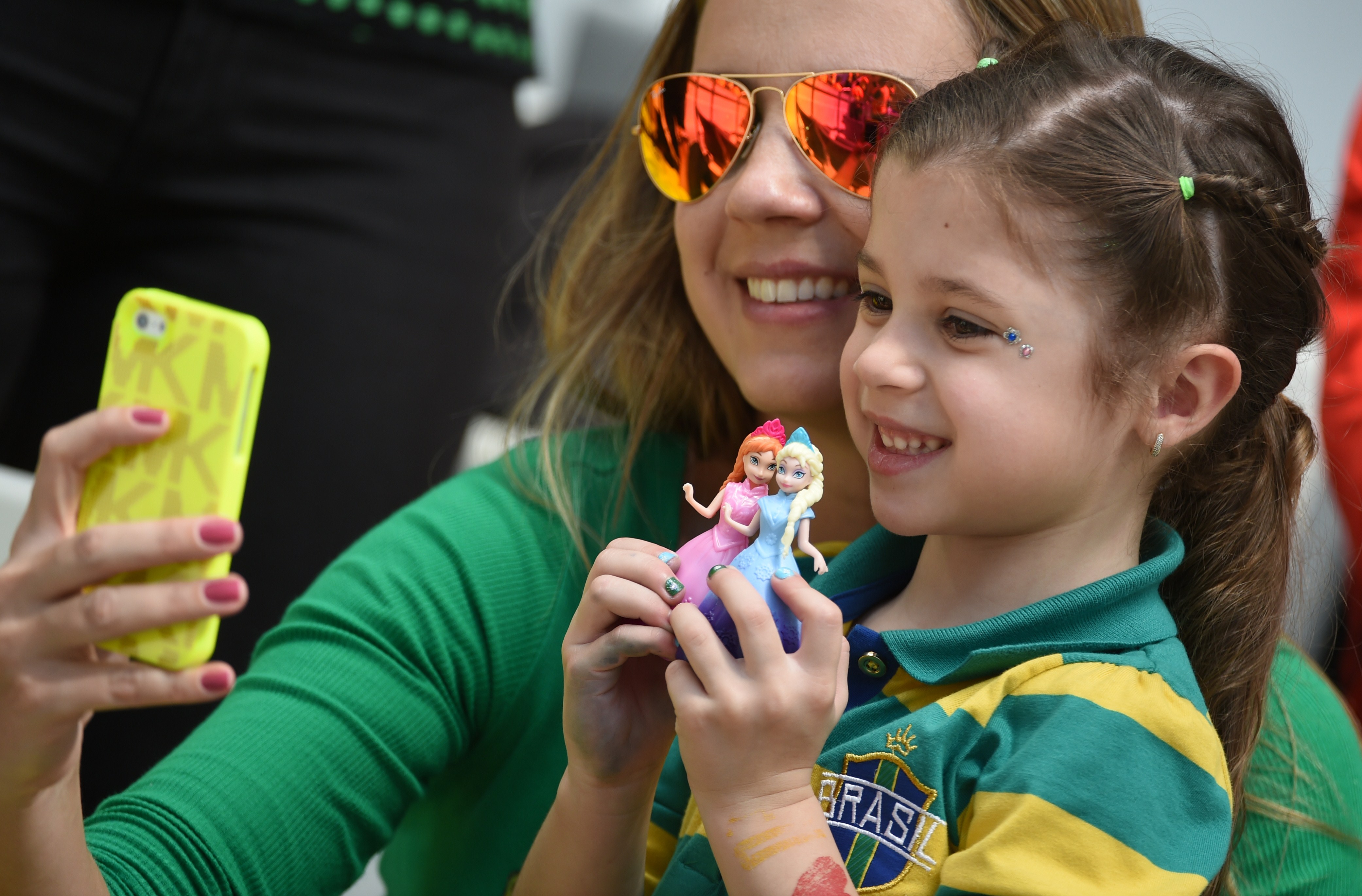 Australian fans take a picture with a smartphone before a Group B football match between Australia and Spain at the Baixada Arena in Curitiba during the 2014 FIFA World Cup on June 23, 2014.