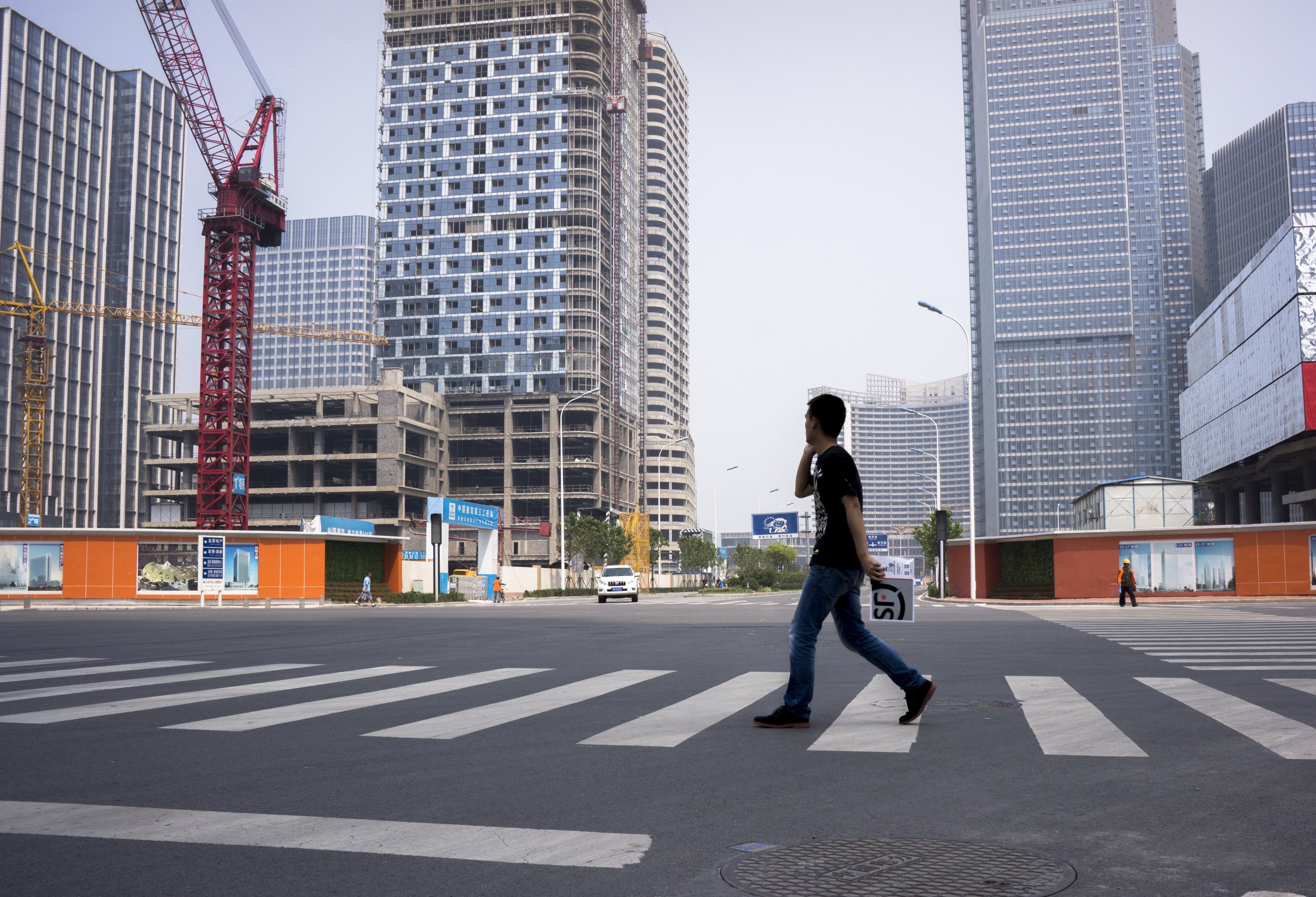 Construction sites and vacant streets in Tianjin, China. The new central business district, under construction in Tianjin, was touted as another Manhattan, but is now a ghost city. The nation's slowing economy is putting the project into jeopardy (Zhang Peng—LightRocket/Getty Images)