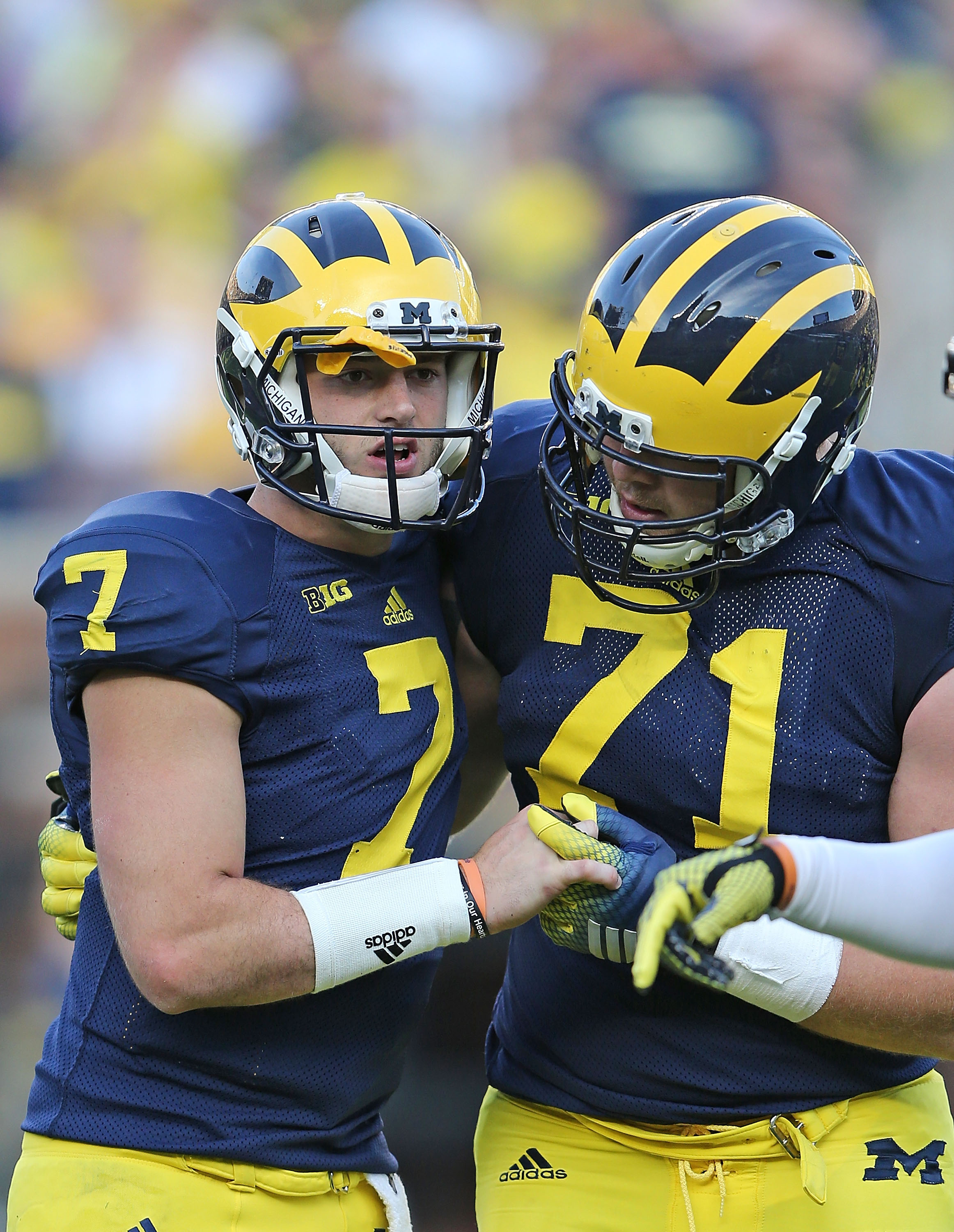 Quarterback Shane Morris (#7) of the Michigan Wolverines is helped off the field by Ben Braden (#71) during the fourth quarter of the game against the Minnesota Golden Gophers on Sept. 27, 2014, at Michigan Stadium in Ann Arbor, Mich. (Leon Halip&mdash;Getty Images)