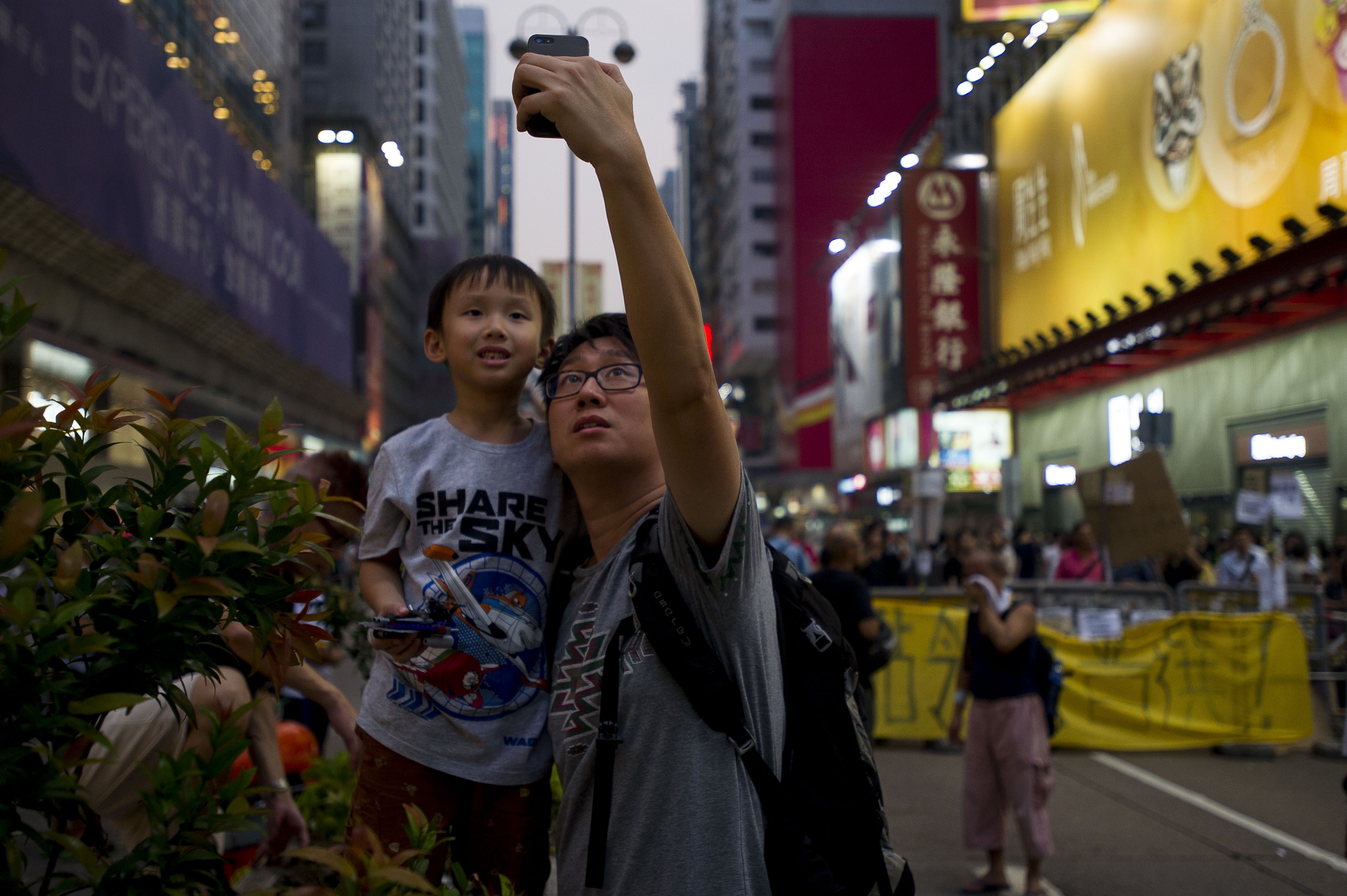 A father and son take a selfie with a mobile phone in front of a barricade in the Mong Kok district of Hong Kong on Sept. 30, 2014 (Xaume Olleros—AFP/Getty Images)