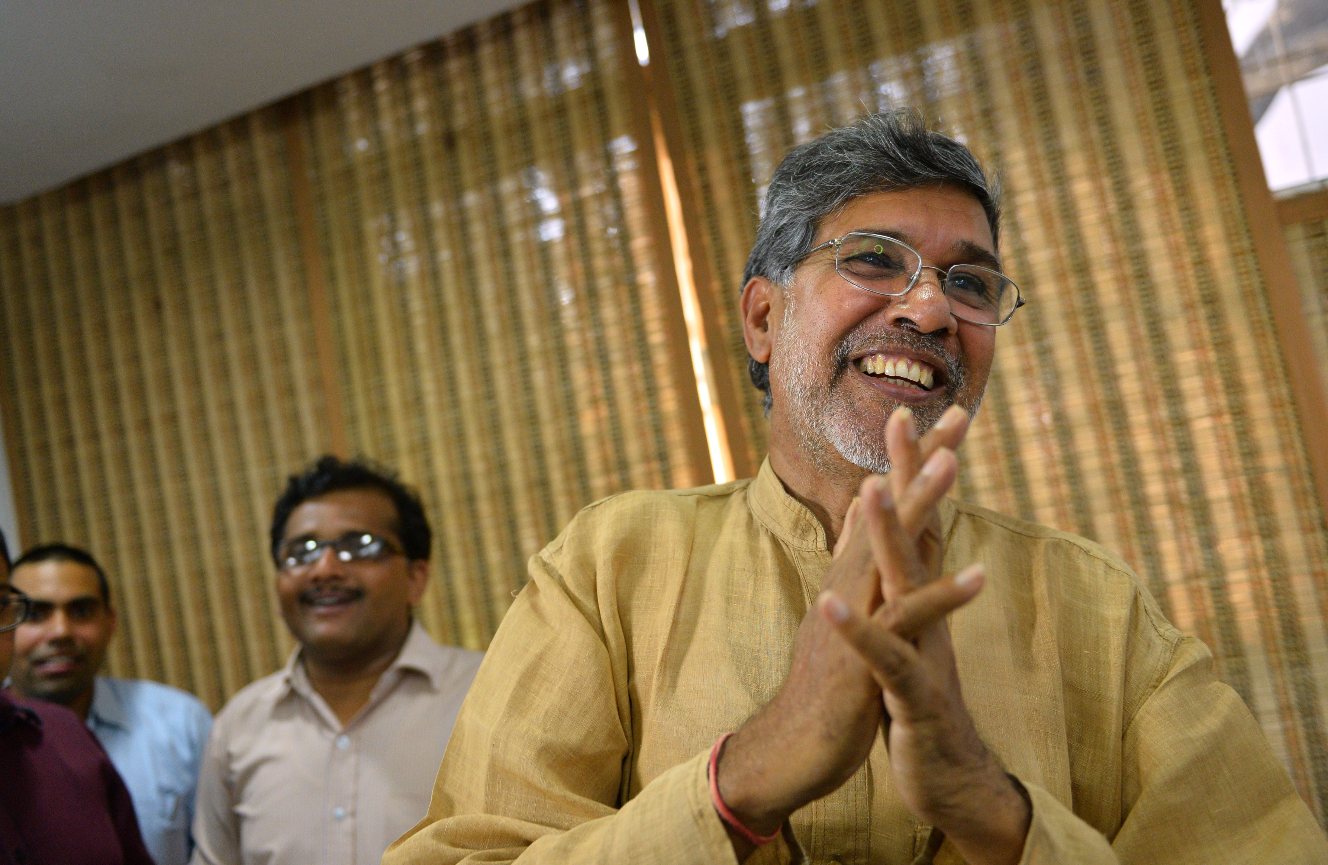 Indian activist Kailash Satyarthi gestures to journalists at this home office after the announcement of him receiving the Nobel Peace Prize, in New Delhi on October 10, 2014. (Chandan Khanna&mdash;AFP/Getty Images)