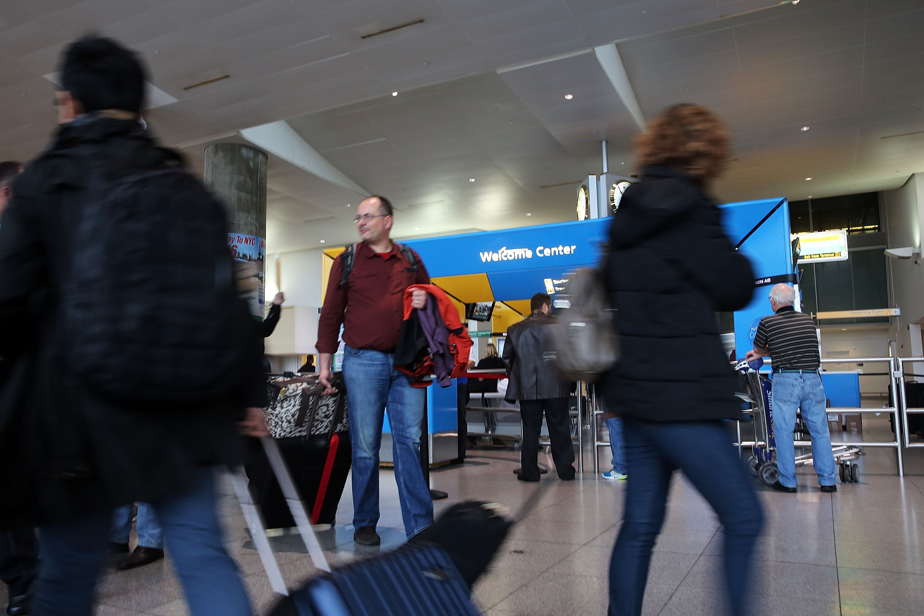 People arrive at the international arrivals terminal at New York's John F. Kennedy Airport  (JFK ) airport on October 11, 2014 in New York City. (Spencer Platt&mdash;Getty Images)