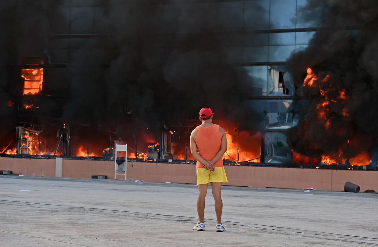 A man stares at the blazing government headquarters in Chilpancingo, in Mexico's Guerrero state, on Oct. 13, 2014, after protesters set it on fire during demonstrations demanding the return of the 43 students still missing since an attack by rogue officers earlier this month (Yuri Cortez—AFP/Getty Images)
