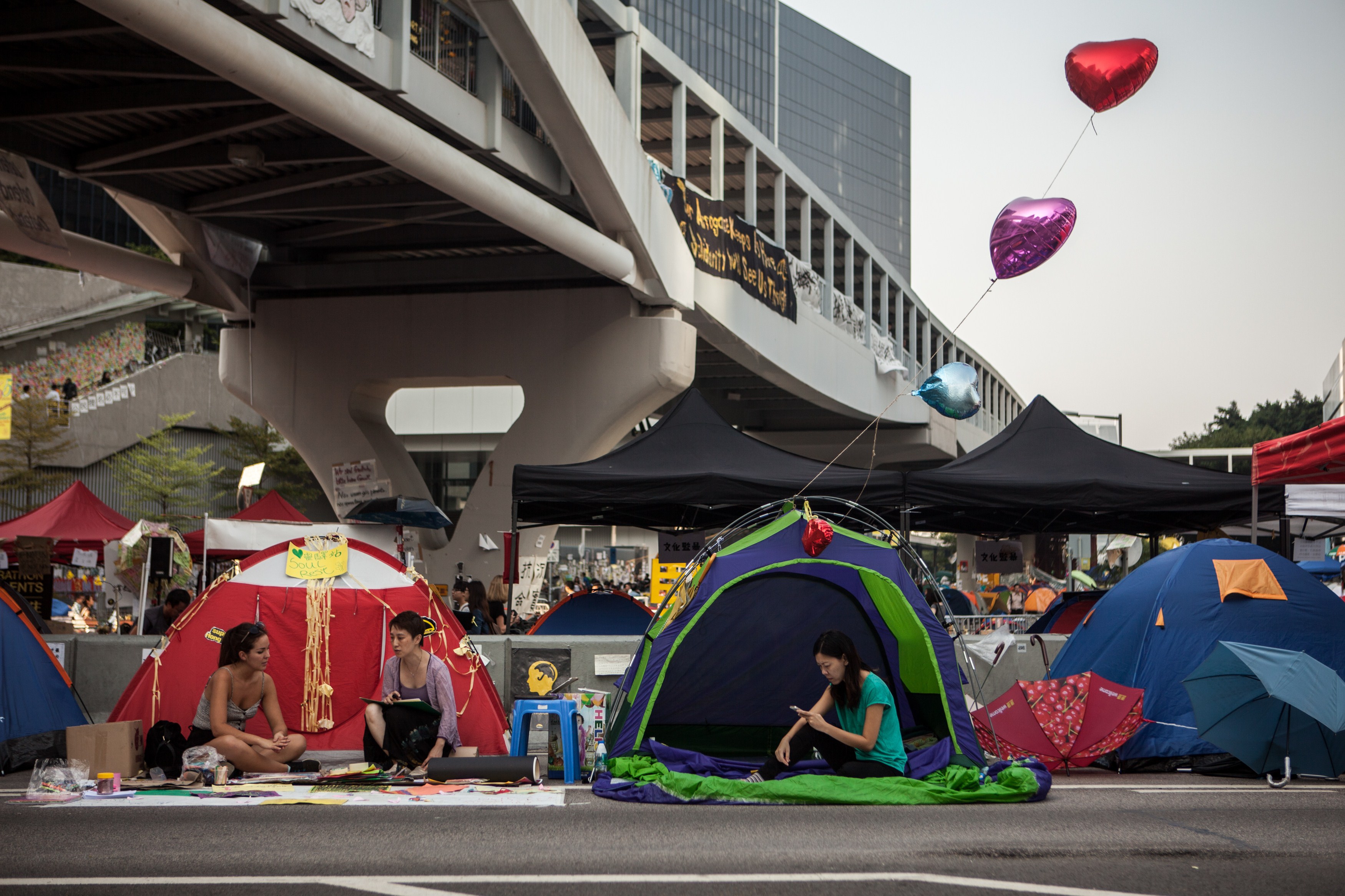 Members of the Occupied movement rest in their tents on a highway blocked by protestor barricades in the Admiralty district of Hong Kong on October 16, 2014. (ANTHONY WALLACE—AFP/Getty Images)