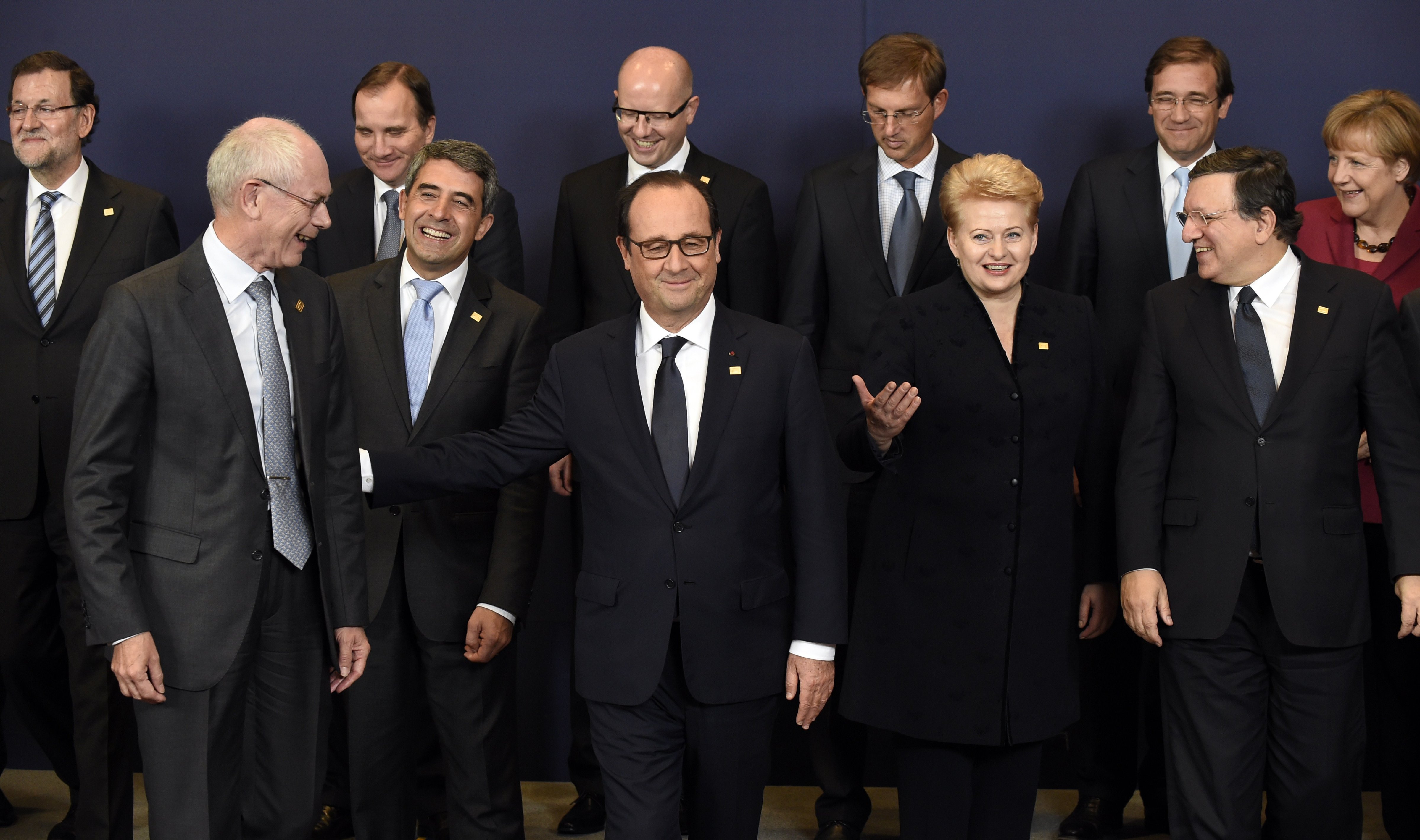 European heads of state and government (from back left) Spanish Prime Minister Mariano Rajoy, Swedish Prime Minister Stefan Loefven, Czech Prime Minister Bohuslav Sobotka, Slovenian Prime Minister Miro Cerar, Portuguese Prime Minister Pedro Passos Coelho and German Chancellor Angela Merkel (from front left) European Council President Herman Van Rompuy, Bulgarian President  Rosen Plevneliev, French President  Francois Hollande, Lithuanian President Dalia Grybauskaite and European Commission President Jose Manuel Barroso talk before a family photo during a European Union summit at the EU headquarters in Brussels on Oct 23, 2014.