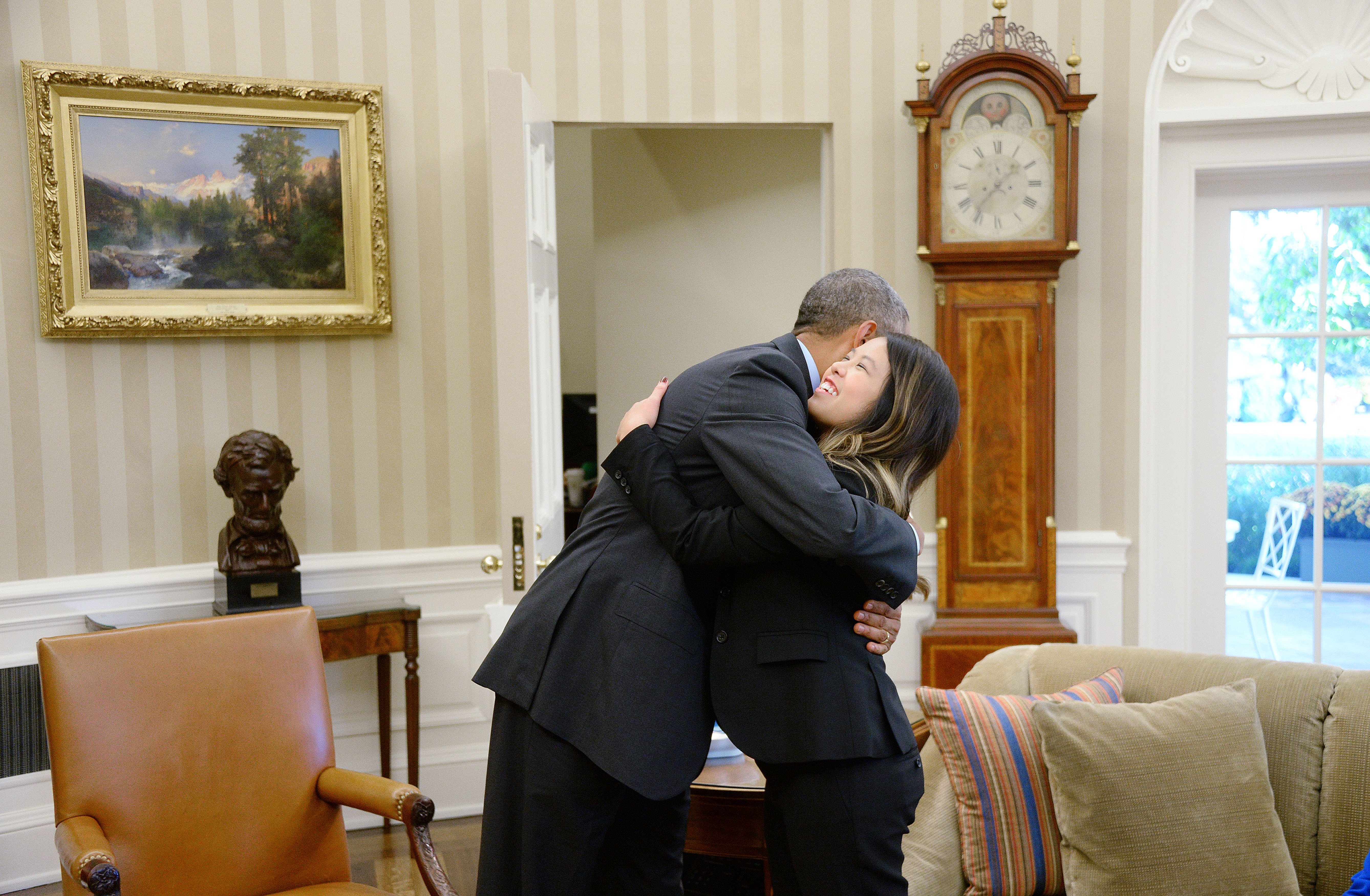 Oct. 24, 2014. U.S. President Barack Obama gives a hug to Dallas nurse Nina Pham in the Oval Office of the White House October 24, 2014 in Washington, DC. Pham, a nurse who was infected with Ebola from treating patient Thomas Eric Duncan at Texas Health Presbyterian Hospital in Dallas and was first diagnosed on October 12, was declared free of the virus.