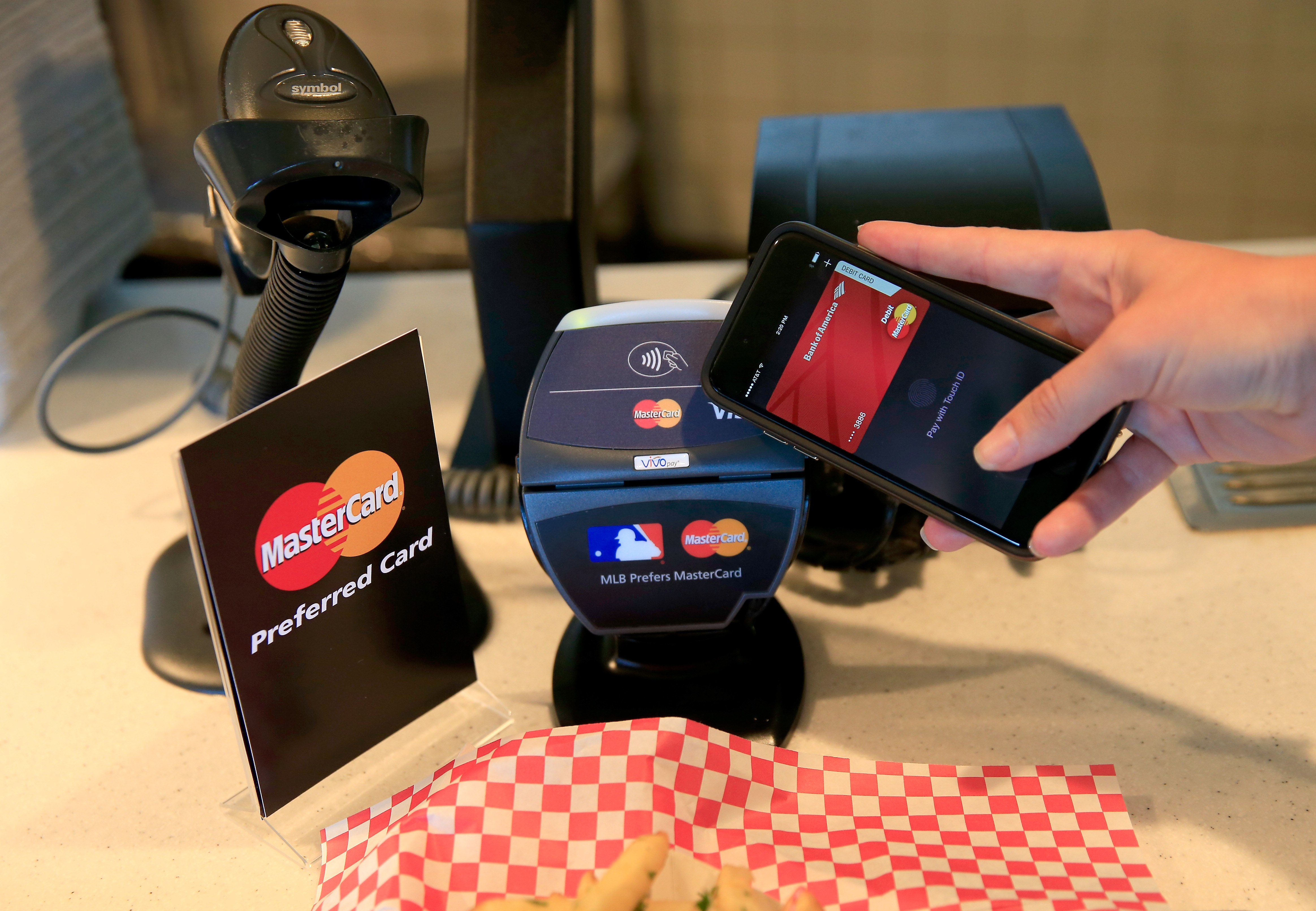A fan uses MasterCard with Apple Pay to pay for garlic fries before Game Three of the 2014 World Series at AT&amp;T Park on October 24, 2014 in San Francisco, California. (Rob Carr—Getty Images)