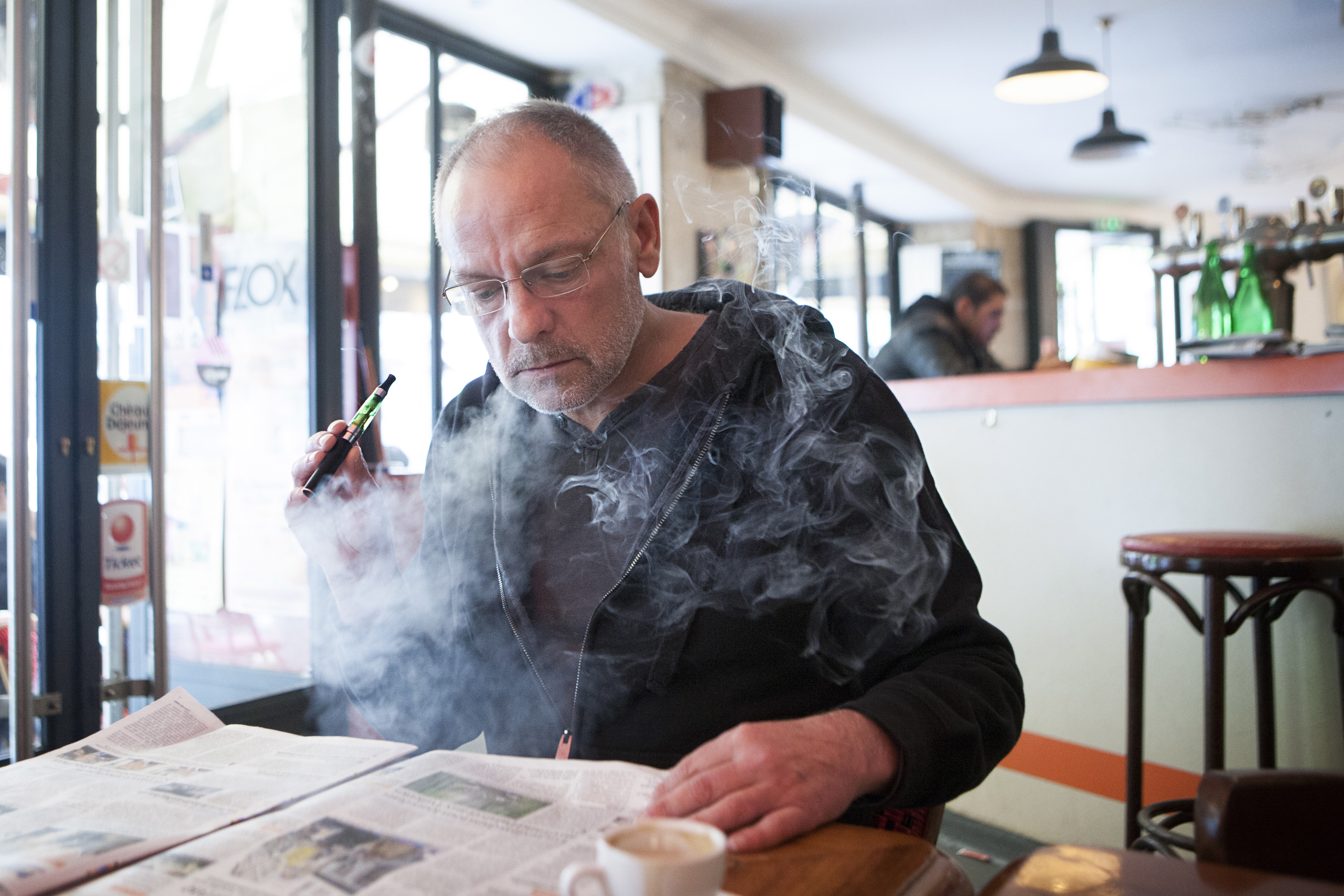 Man with an electronic cigarette in a public place.