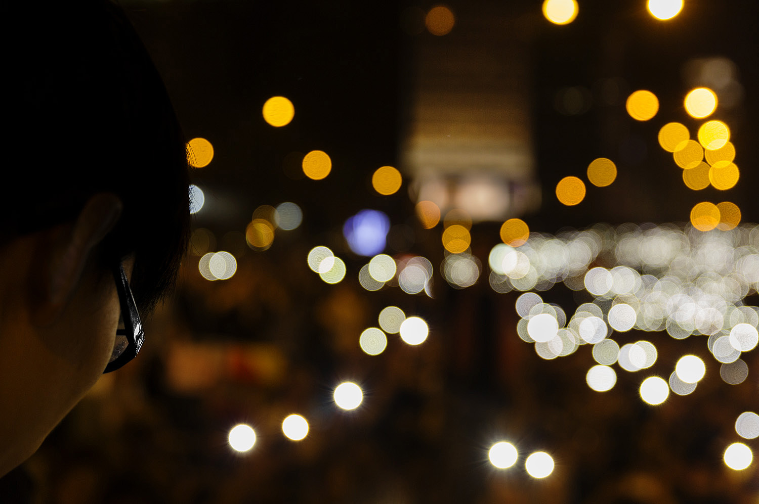 Teenager Joshua Wong, the leader for Hong Kong’s protest movement, looks out over a crowd of people waving their cell phones.