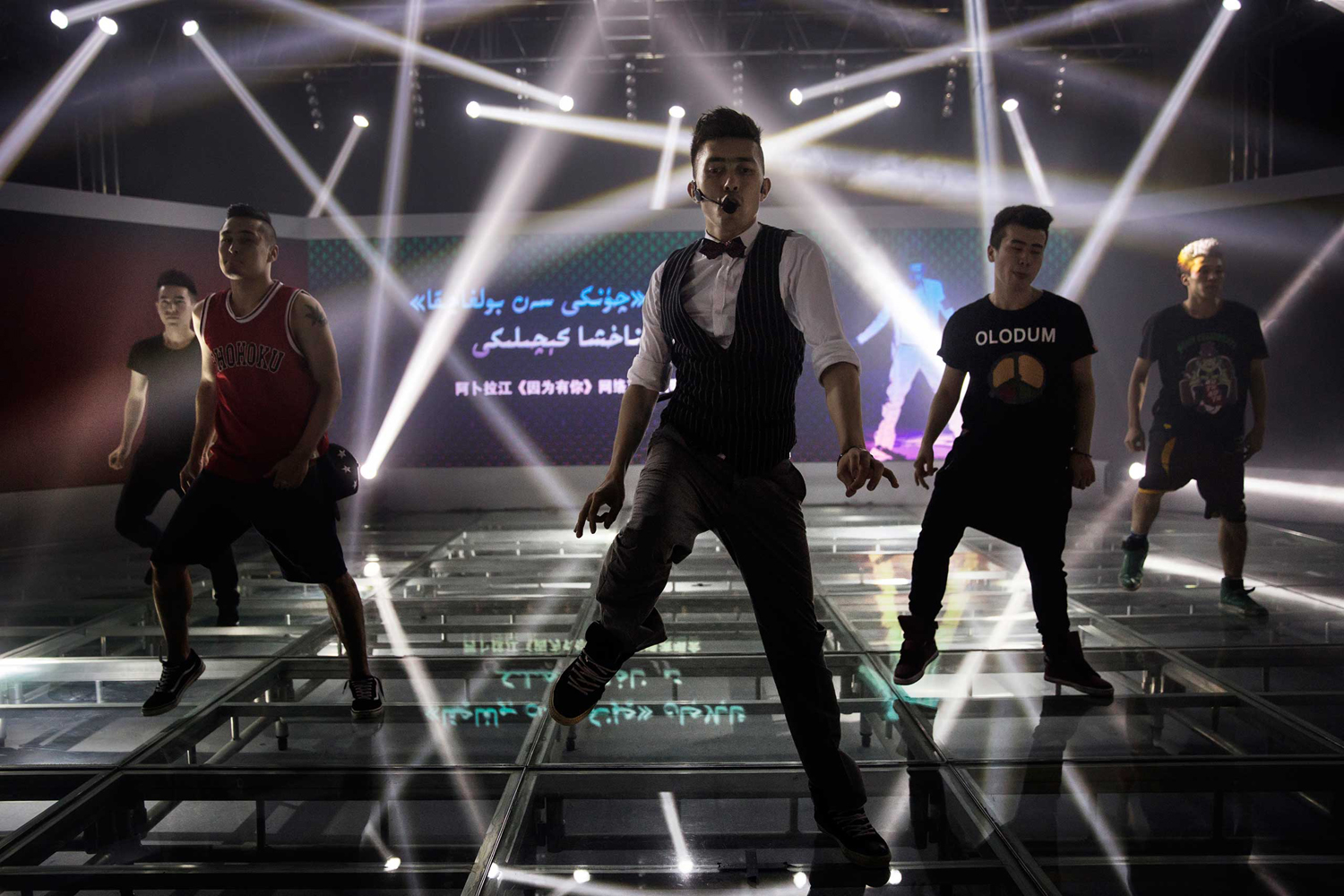 Uighur pop star Ablajan performs on stage with his dancers at rehearsals for a planned live webcast concert scheduled for that afternoon in Urumqi, China on July 31, 2014.