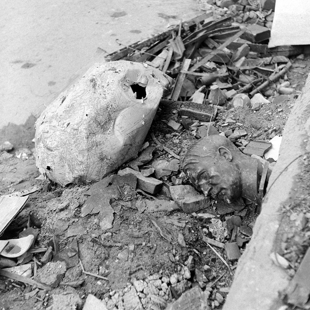 An image almost too perfectly symbolic of Berlin in 1945: A crushed globe and a bust of Hitler amid rubble outside the ruined Reich Chancellery.