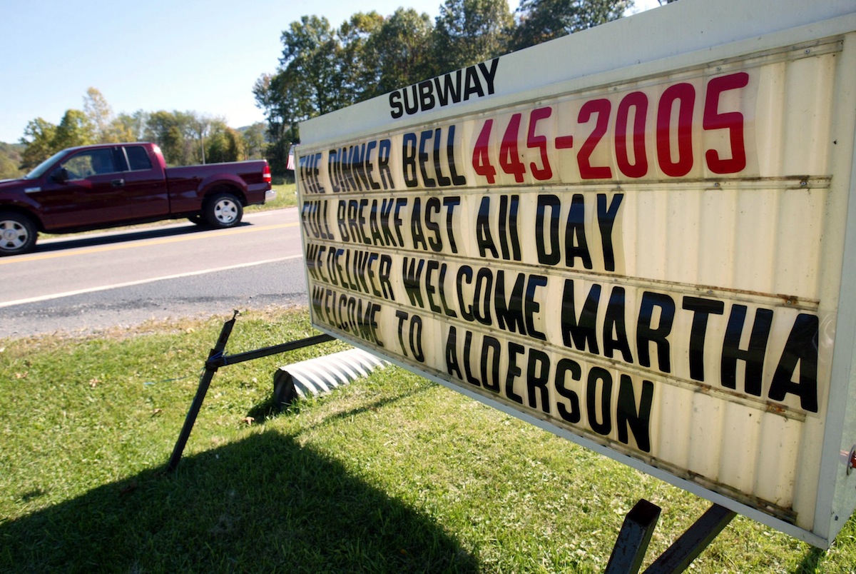 A sign welcomes Martha Stewart to town near Alderson Federal Prison Camp where Martha Stewart turned herself in Oct. 8, 2004, in Alderson, W.V. (Joe Raedle—Getty Images)