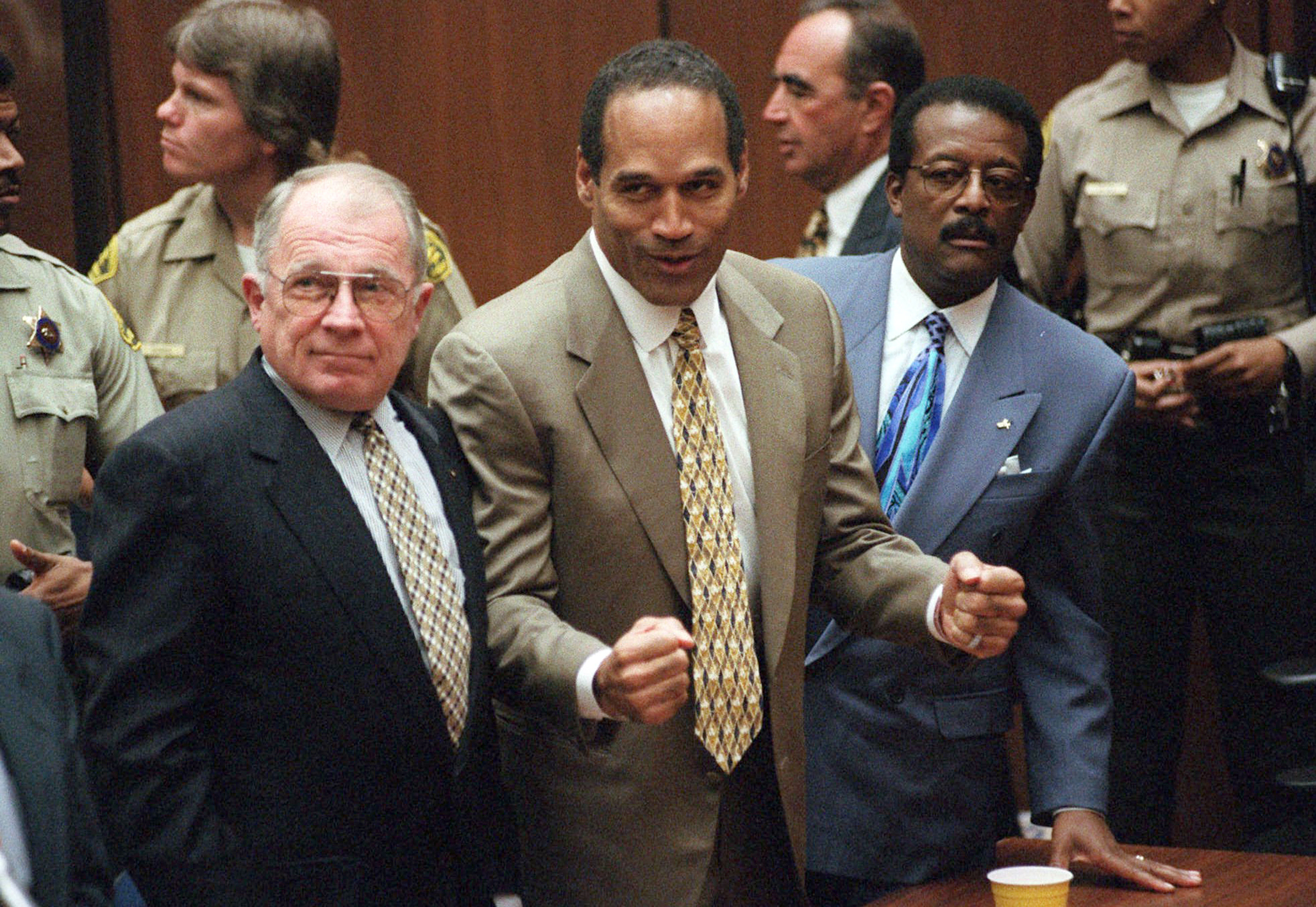 O.J. Simpson reacts as he is found not guilty of murdering his ex-wife Nicole Brown Simpson and her friend Ron Goldman, at the Criminal Courts Building in Los Angeles. At left is defense lawyer F. Lee Bailey and at right is defense attorney Johnnie Cochran Jr. Defense attorney Robert Shapiro is in profile behind them. (AP Photo/Daily News, Myung J. Chun, Pool, File) (Myung J. Chun&mdash;ASSOCIATED PRESS)