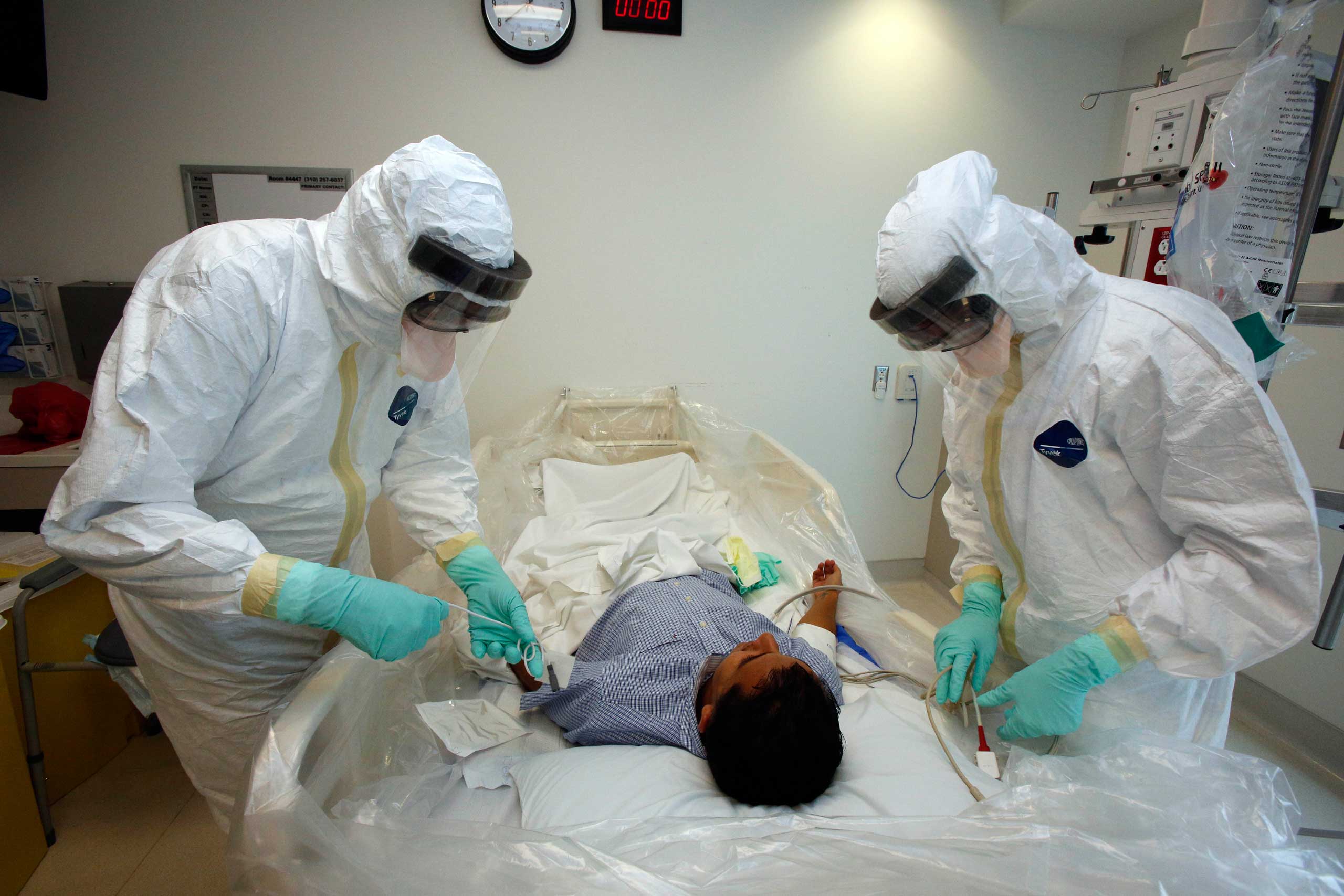 Doctors and staff participate in a preparadness exercise on diagnosing and treating patients with Ebola virus symptoms, at the Ronald Reagan UCLA Medical Center in Los Angeles. (Reed Hutchinson—AP)