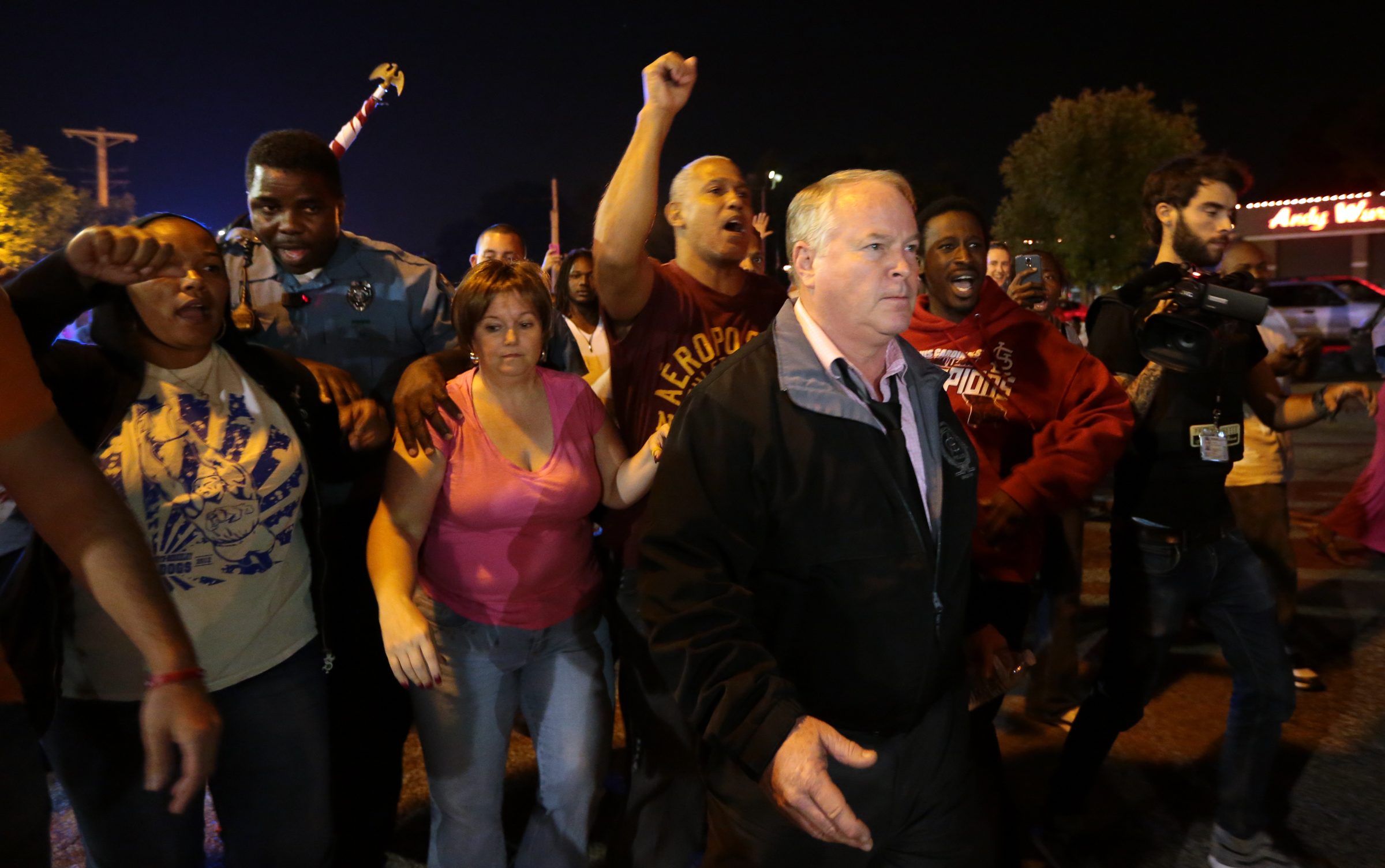 Ferguson Police Chief Tom Jackson begins to march with protesters before clashes led to arrests in front of the Ferguson Police Department, on Thursday, Sept. 25, 2014. (Robert Cohen—AP)
