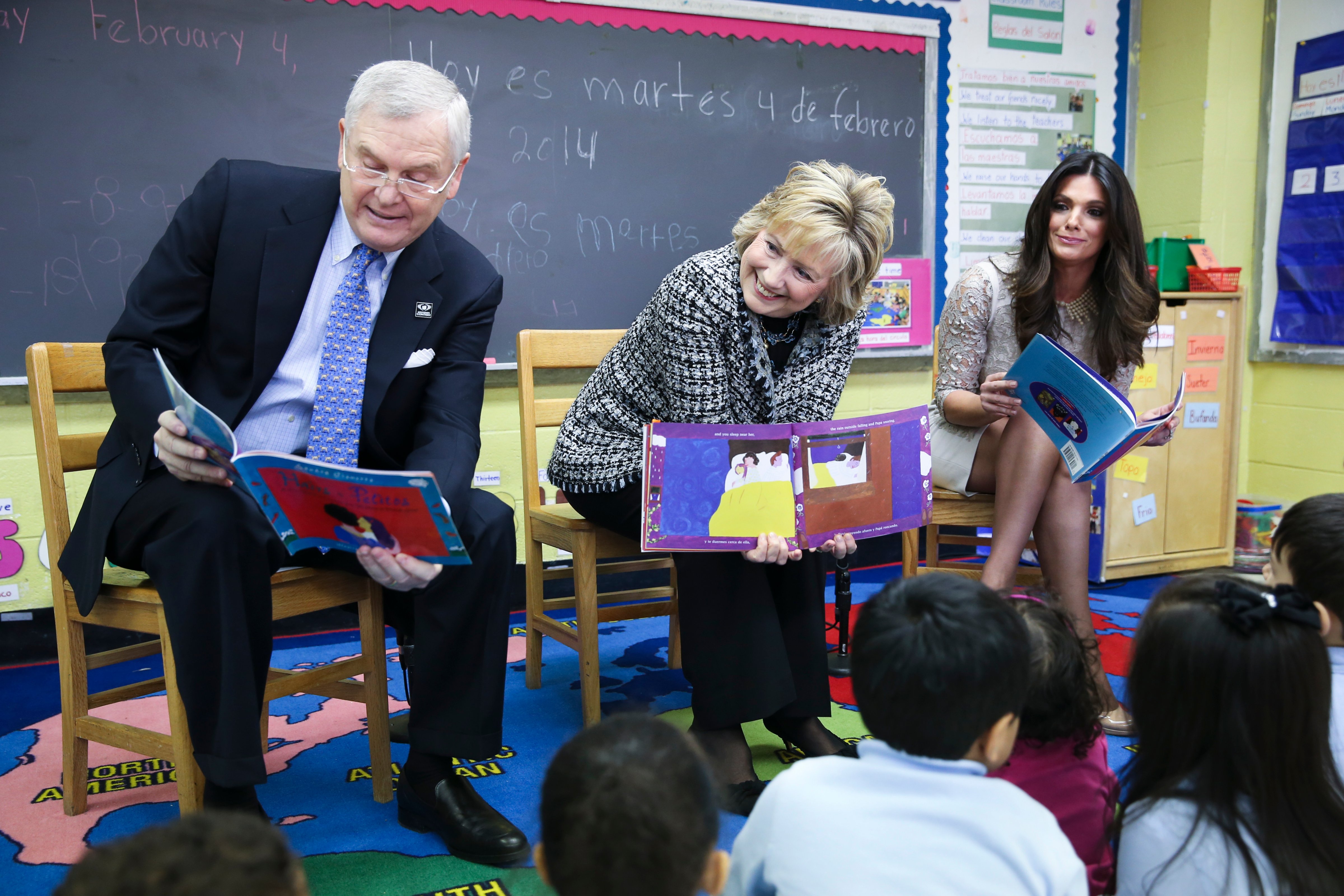 Hillary Rodham Clinton, center, alongside Randy Falco, president and CEO of Univision Communications Inc, left, and Barbara Bermudo, host of Univision's news magazine program "Primer Impacto", right, read to children at the launch of "Pequeños y Valiosos" (Young and Valuable), a parent-focused effort on early childhood development, at the East Harlem Council for Human Services Bilingual Headstart Program, Tuesday, Feb. 4, 2014, in New York. (John Minchillo&mdash;AP Images for Univision)