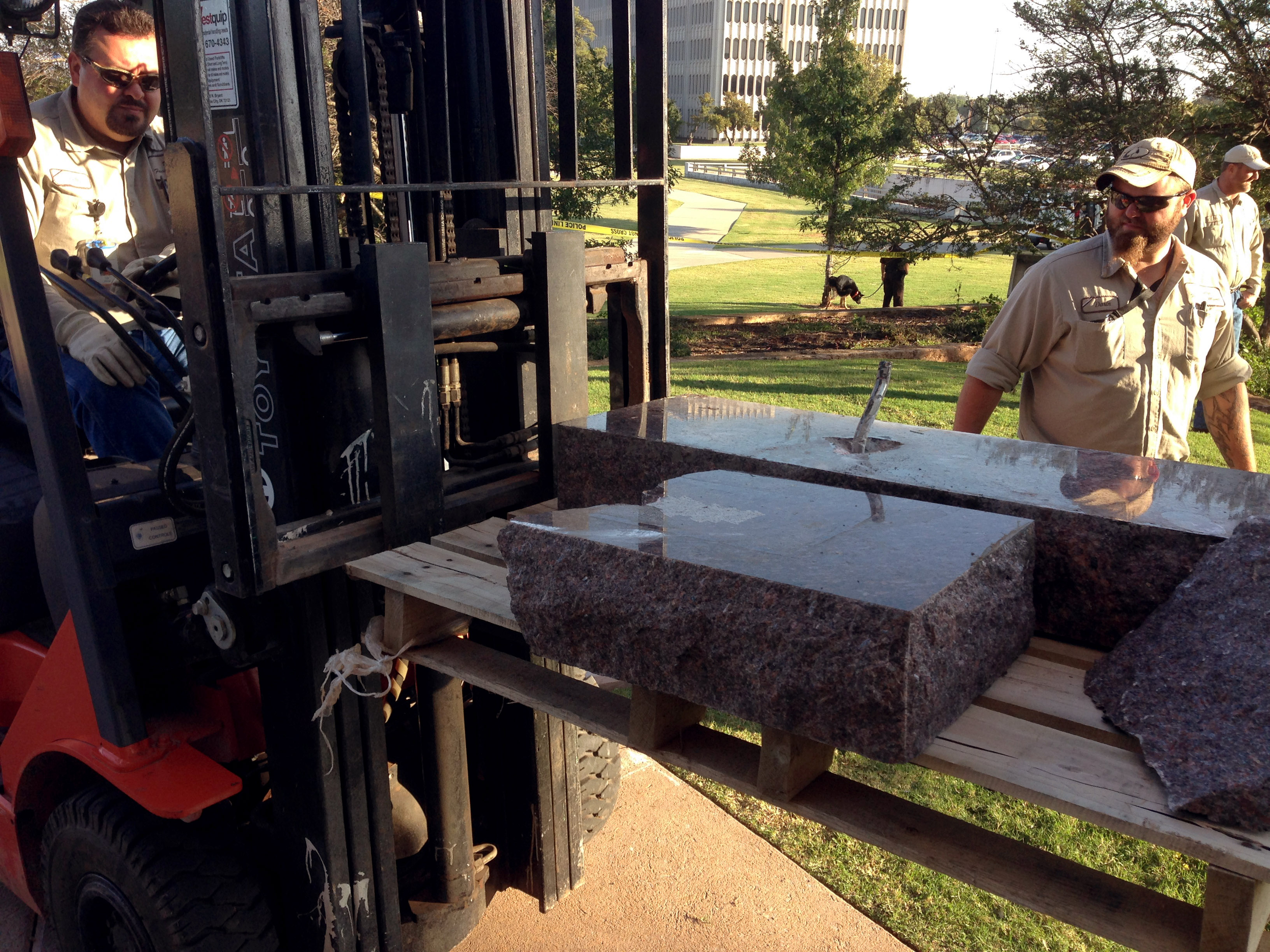 State workers for the Office of Management and Enterprise Services remove the damaged remains of a Ten Commandments monument from the Oklahoma State Capitol grounds on Oct. 24, 2014 in Oklahoma City.