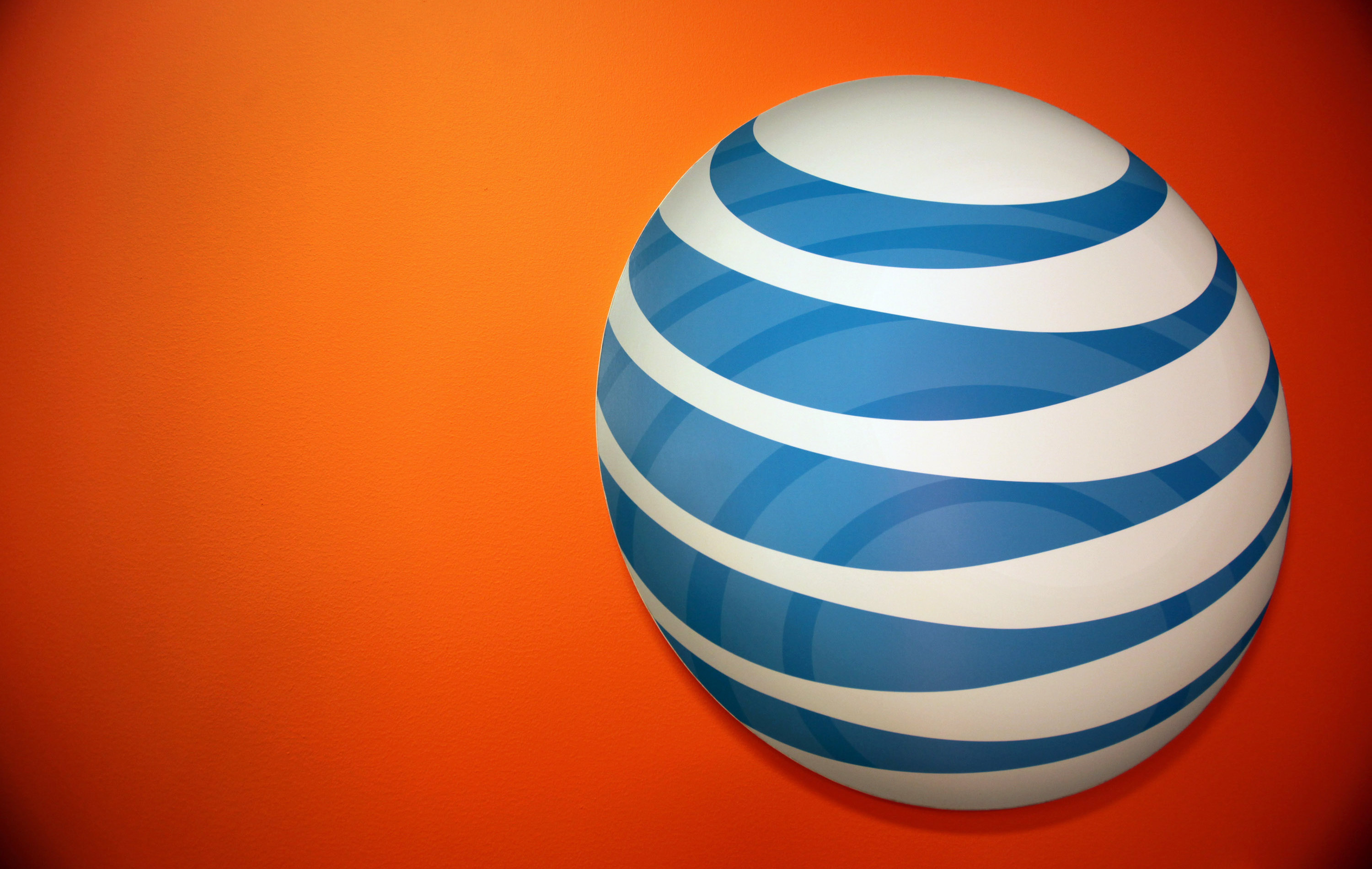 The AT&amp;T Inc. logo is displayed at the company's new store in Chicago, Illinois, U.S., on Friday, Sept. 30, 2011. (Bloomberg/Getty Images)