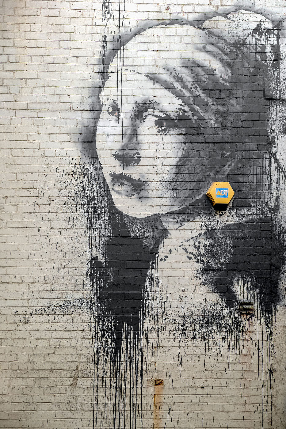 The new Banksy depicting the painting 'Girl with a Pearl Earring' by Dutch painter Johannes Vermeer is see on a wall in Bristol Harbourside, England on Oct. 20, 2014.