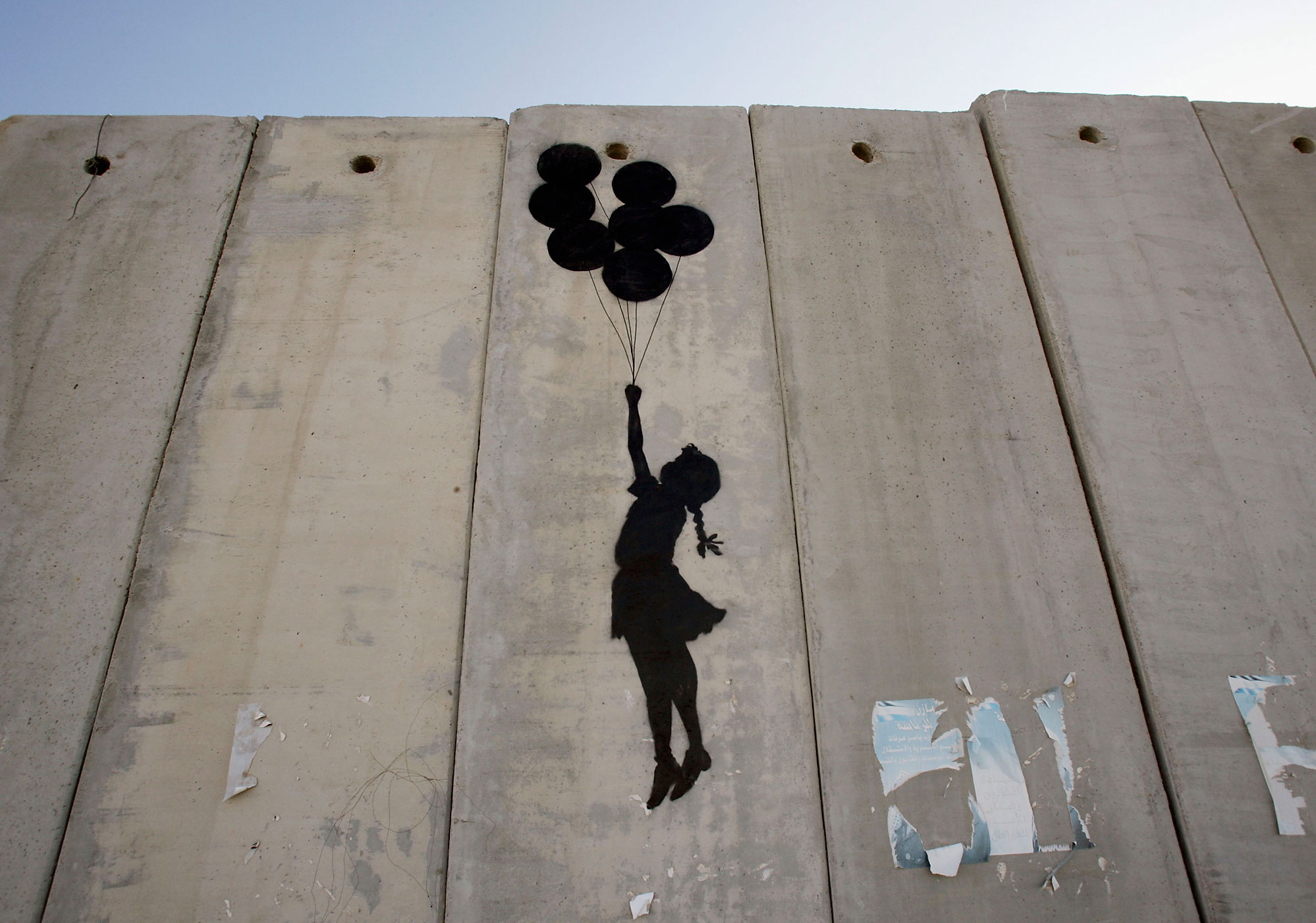 A graffiti titled  Balloon Debate  made by Banksy is seen on Israel's highly controversial West Bank barrier in Ramallah on August 6, 2005.