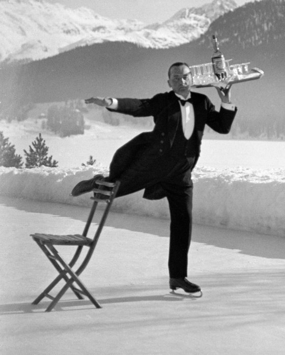 Skating waiter RenŽ Breguet delivers drinks at the Grand Hotel, St. Moritz, 1932.