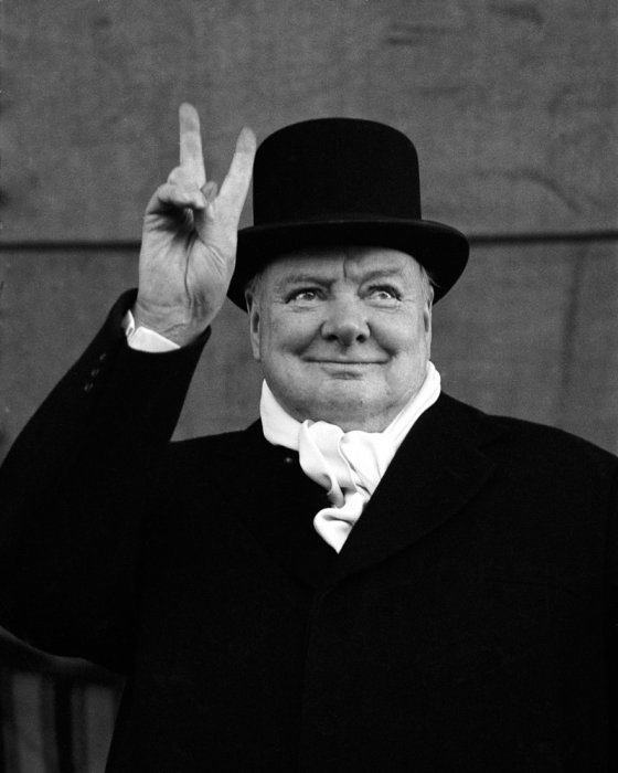 British Prime Minister Winston Churchill flashes his signature 