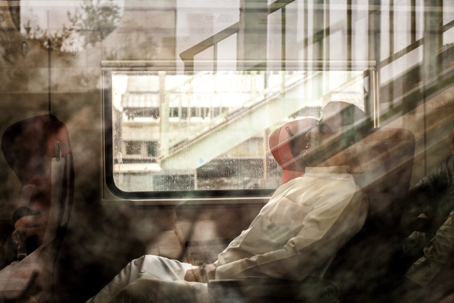 A girl looks out from a sleeping compartment on a new train preparing to leave from Basra to Baghdad, the only passenger rail service currently operational in Iraq.