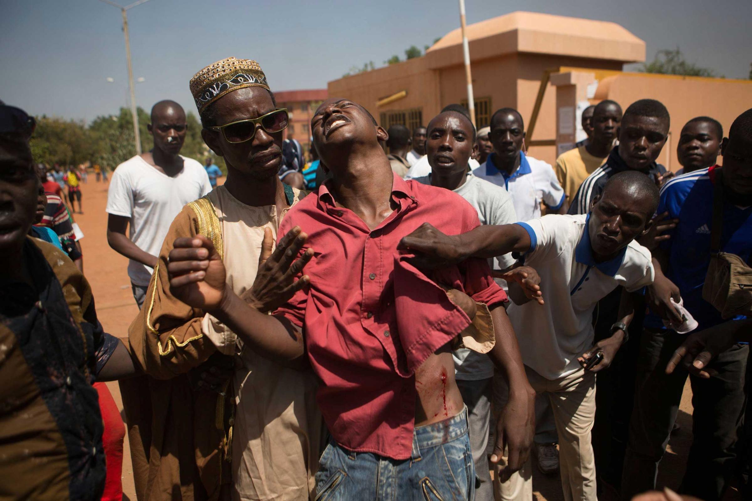 An anti-government protester is shot in Ouagadougou, capital of Burkina Faso, Oct. 30, 2014.