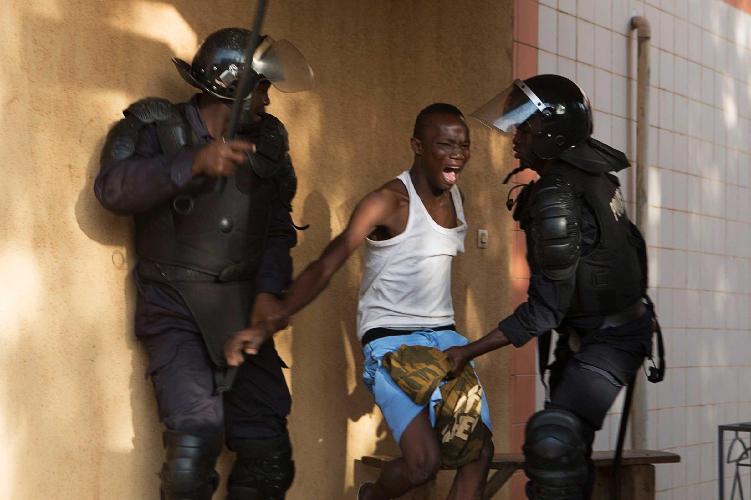 Riot police arrest an anti-government protester in Ouagadougou, capital of Burkina Faso, Oct. 30, 2014.