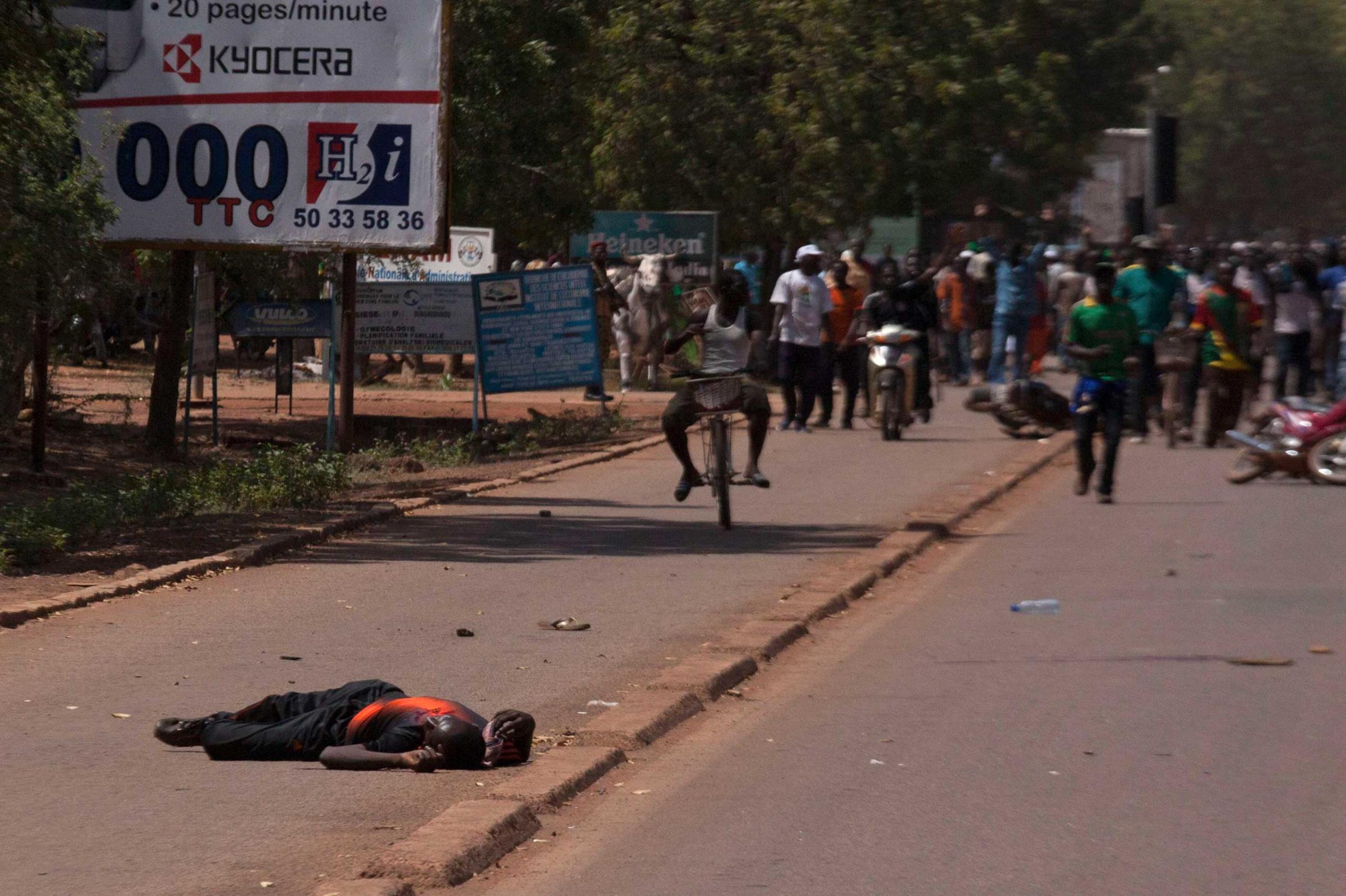 A man lies injured from bullet wounds fired by Burkinabe soldiers in Ouagadougou, capital of Burkina Faso, Oct. 30, 2014.