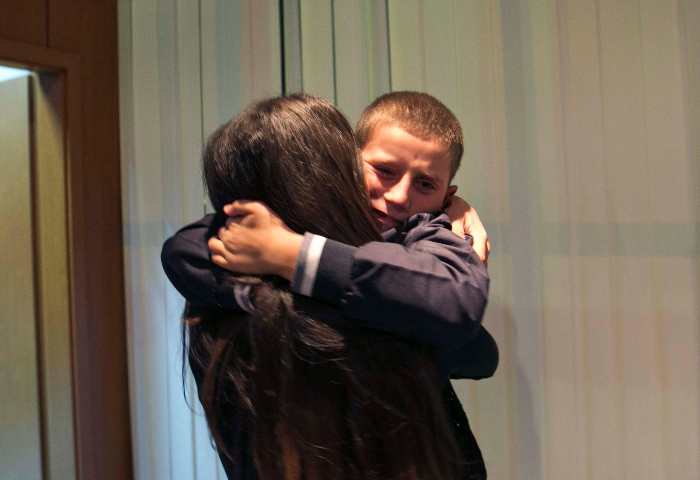 Pranvera Abazi kisses her son Erion Zena during their reunion at Kosovo's main airport upon his return to Kosovo's capital Pristina on Oct. 15, 2014.