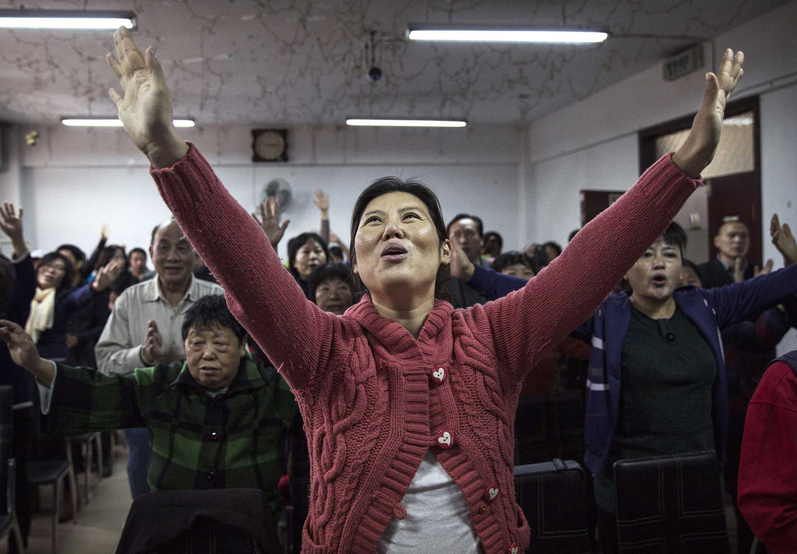 A Christian woman sings during a prayer service.