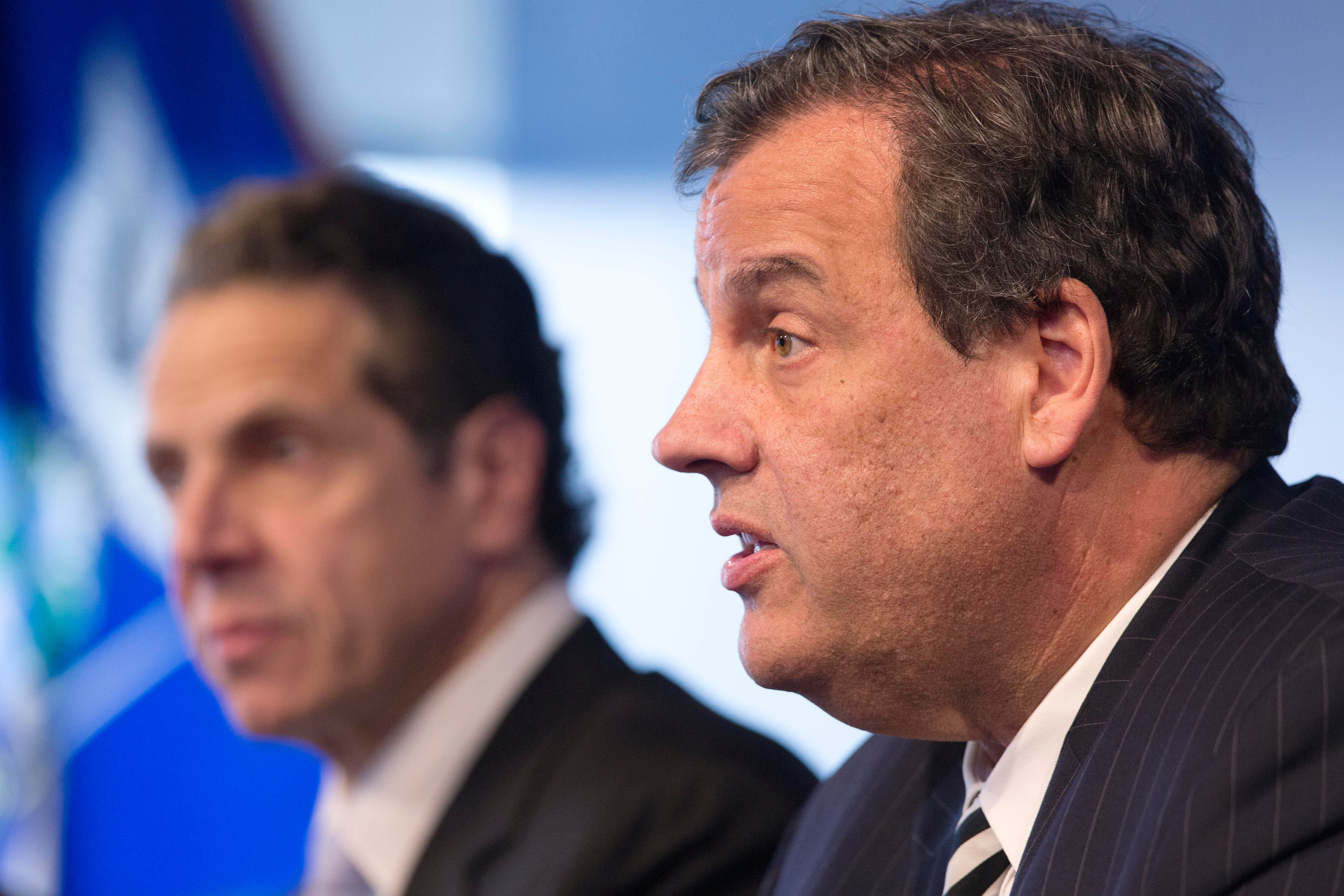 New York Governor Andrew Cuomo listens as New Jersey Governor Chris Christie talks at a news conference ON Oct. 24, 2014 in New York. (Mark Lennihan—AP)